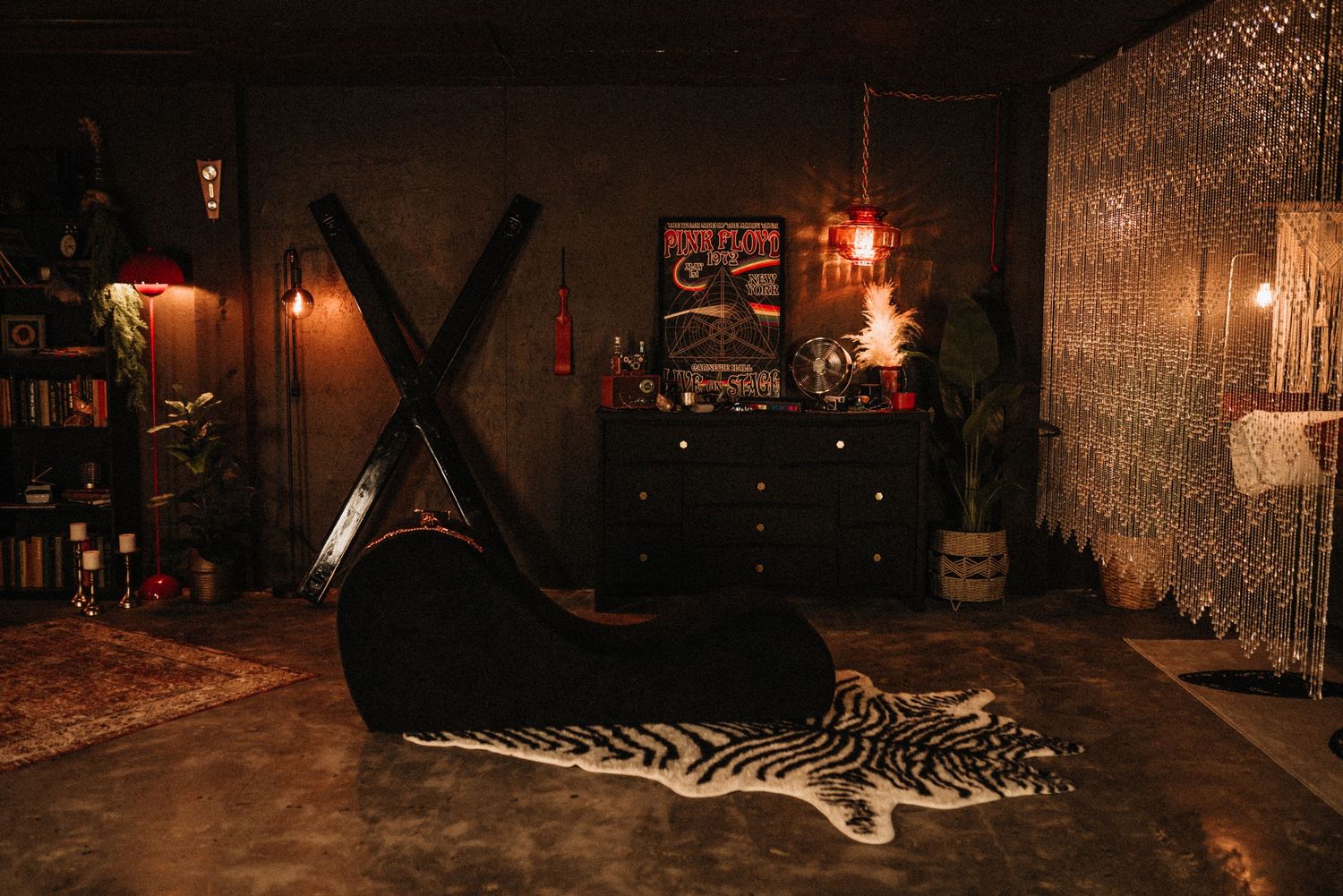 Dark moody interior with vintage furniture and ambient lighting.