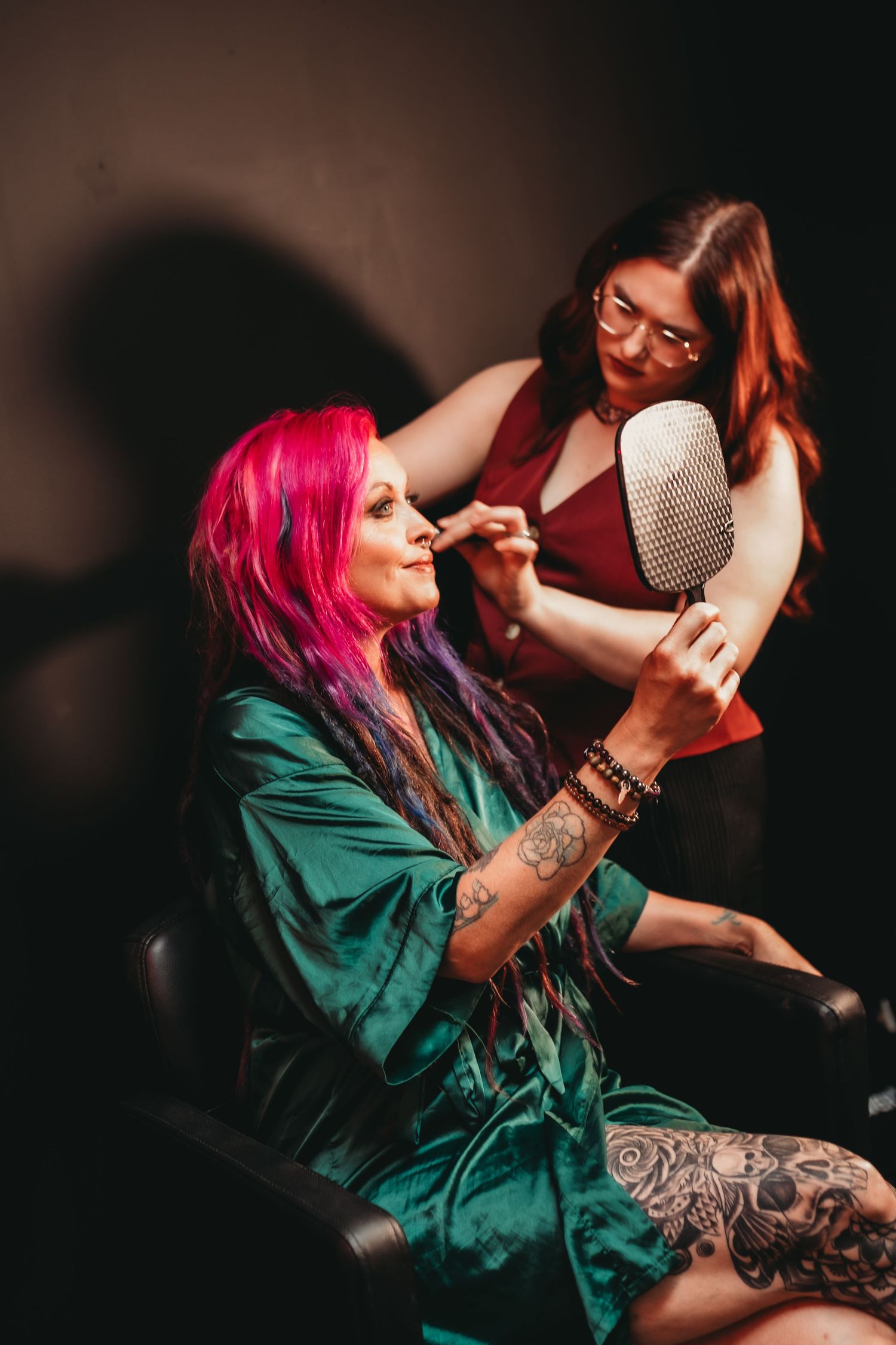 Artistic photoshoot featuring vibrant hair colors and emerald silk robe.