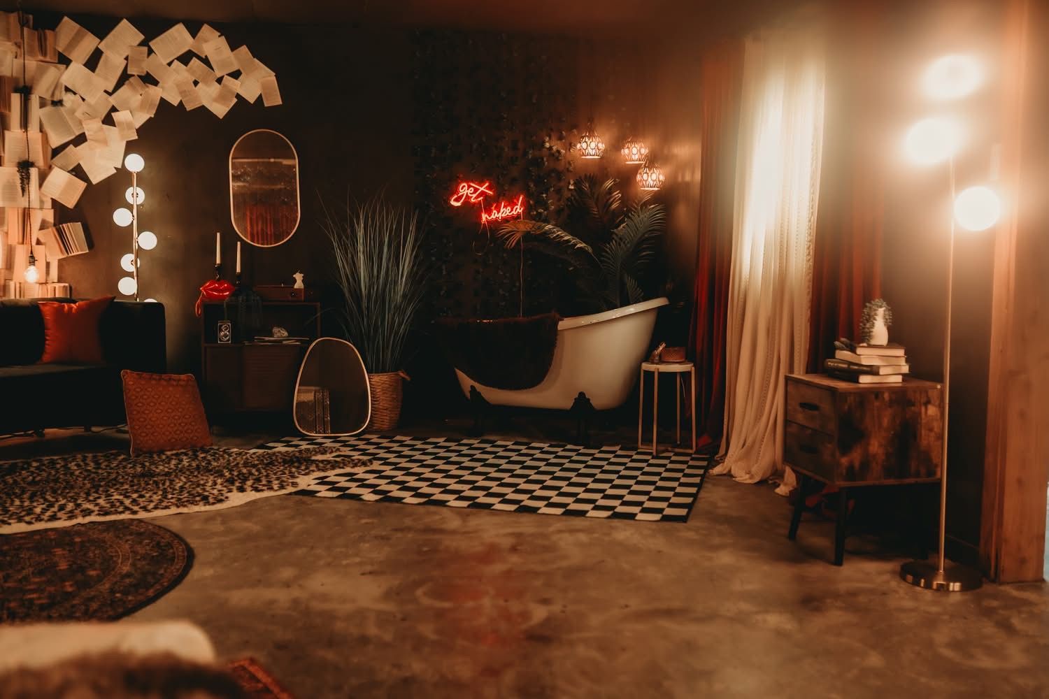 Moody, dimly lit room with a freestanding bathtub on checkered floors, neon lights, and warm ambient lighting.