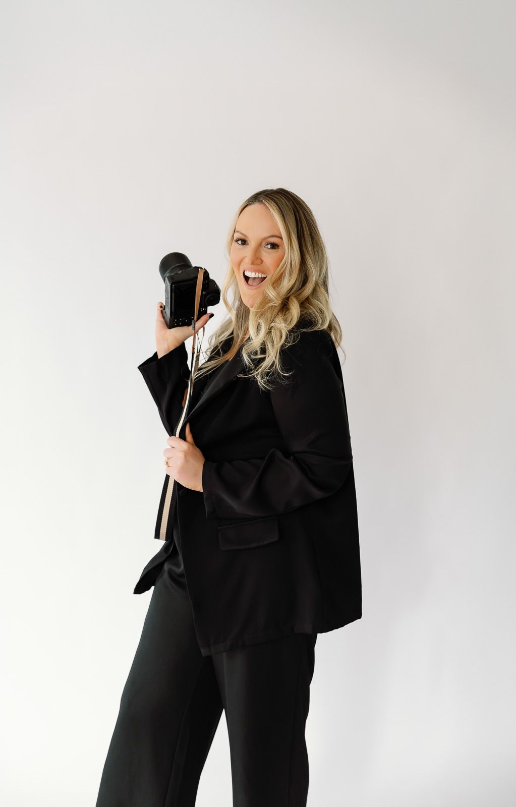 South Jersey wedding photographer shows off a mobile phone against a white background in a series of poses.