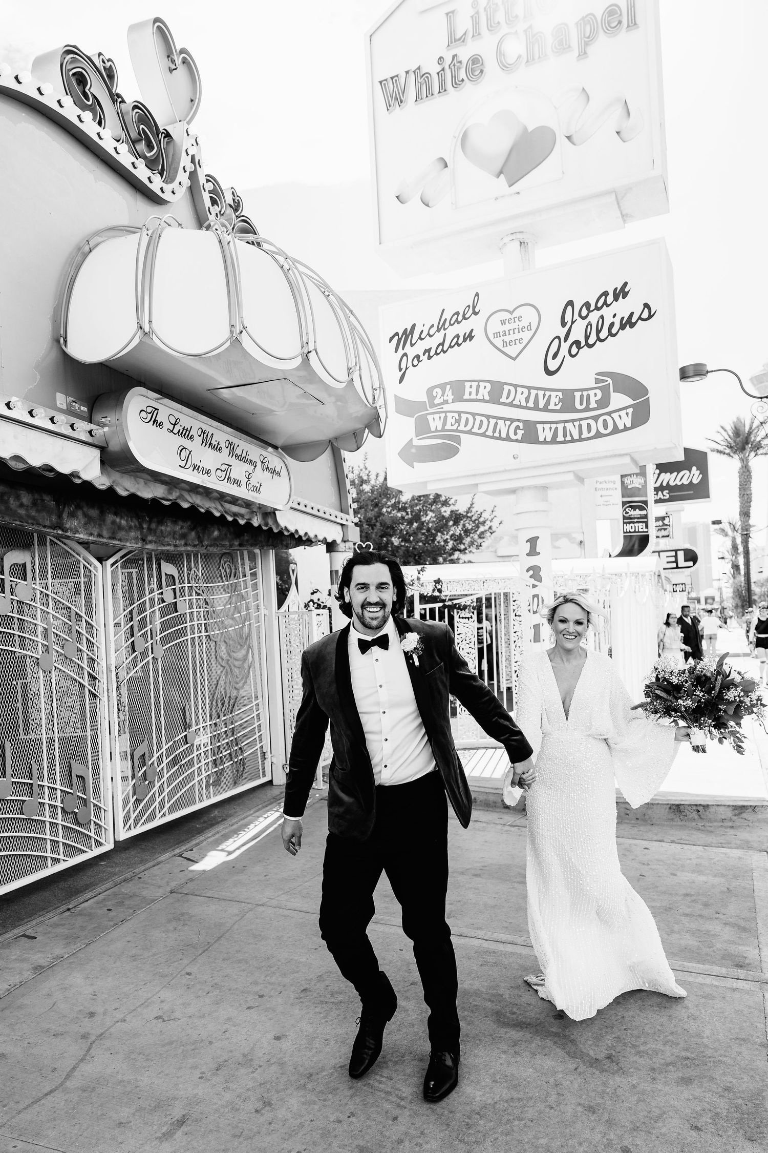 Candid wedding photos of couple running and laughing outside retro chapel building.