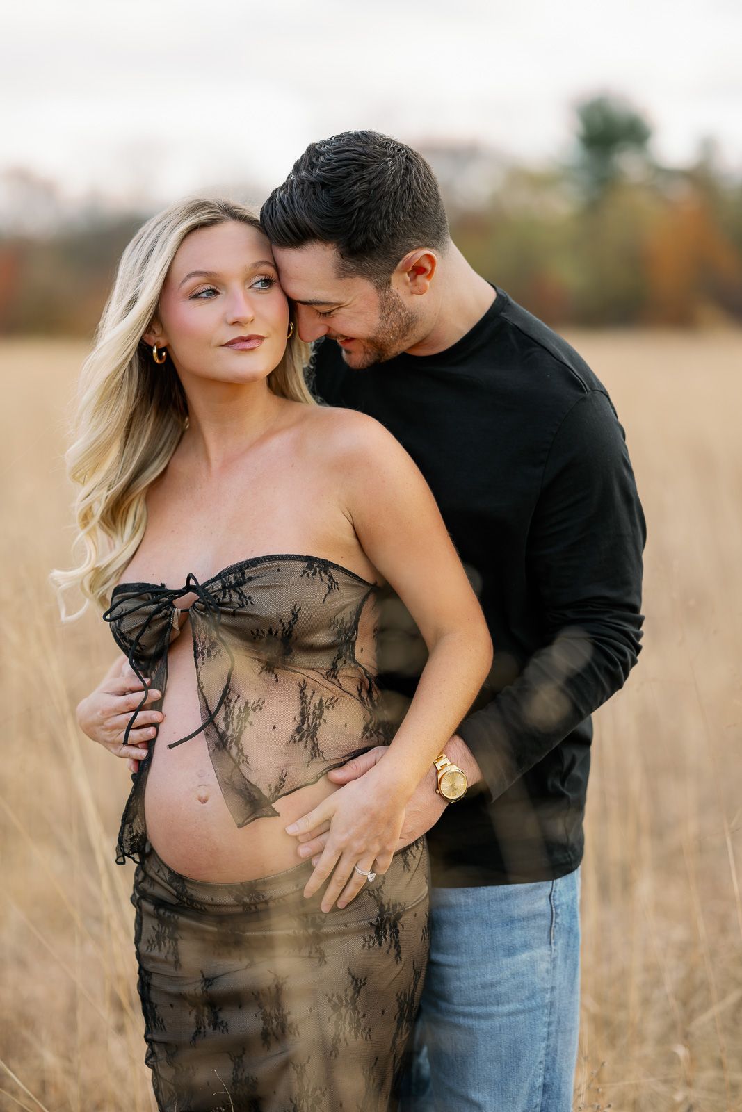 An expecting couples embraces during golden hour during their New Jersey maternity session.