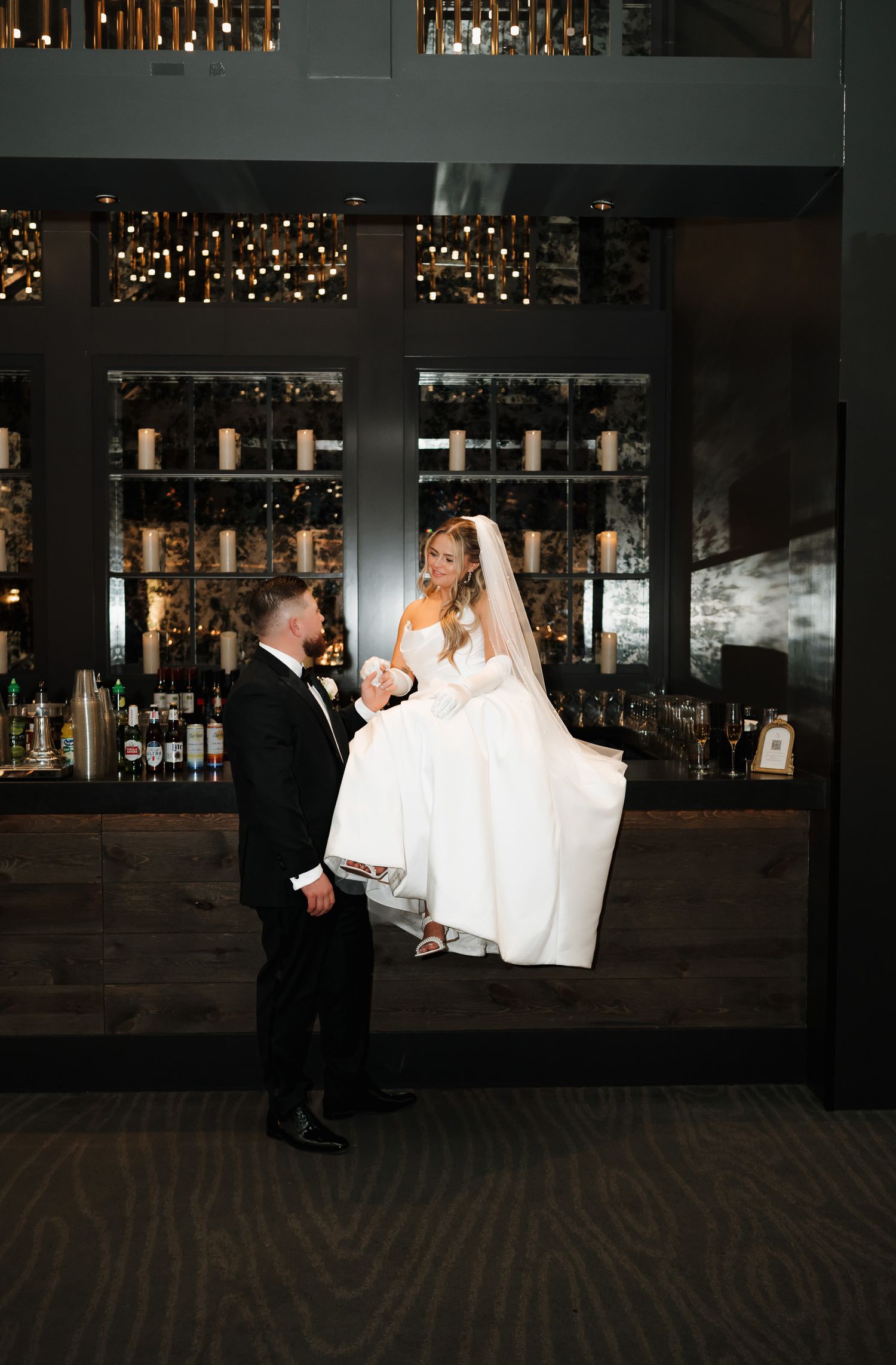 A couple in formal wedding attire dance together in a dimly lit venue captured by a South Jersey wedding photographer.