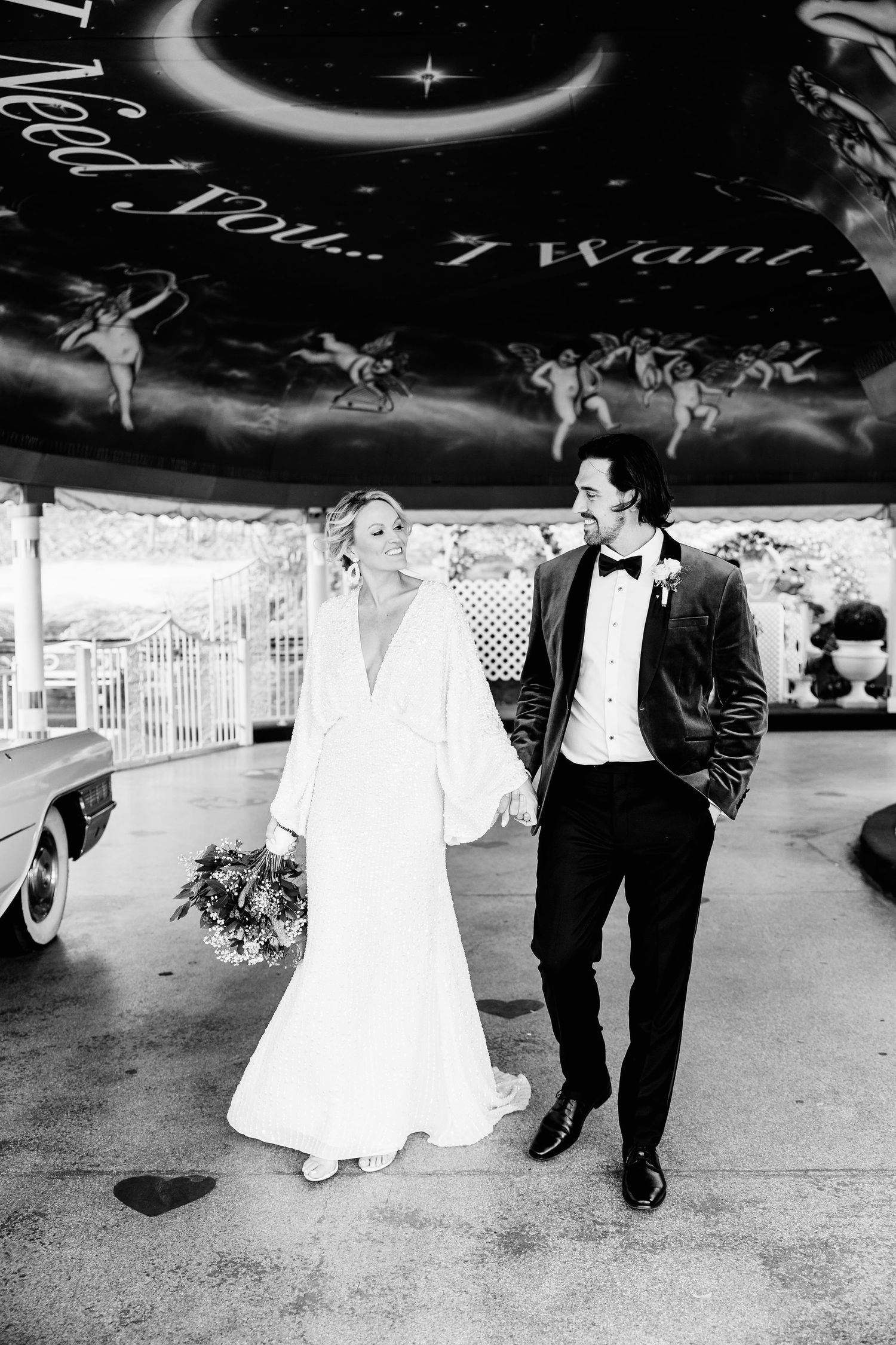 Series showing couple walking together under decorative chapel archways in black and white.