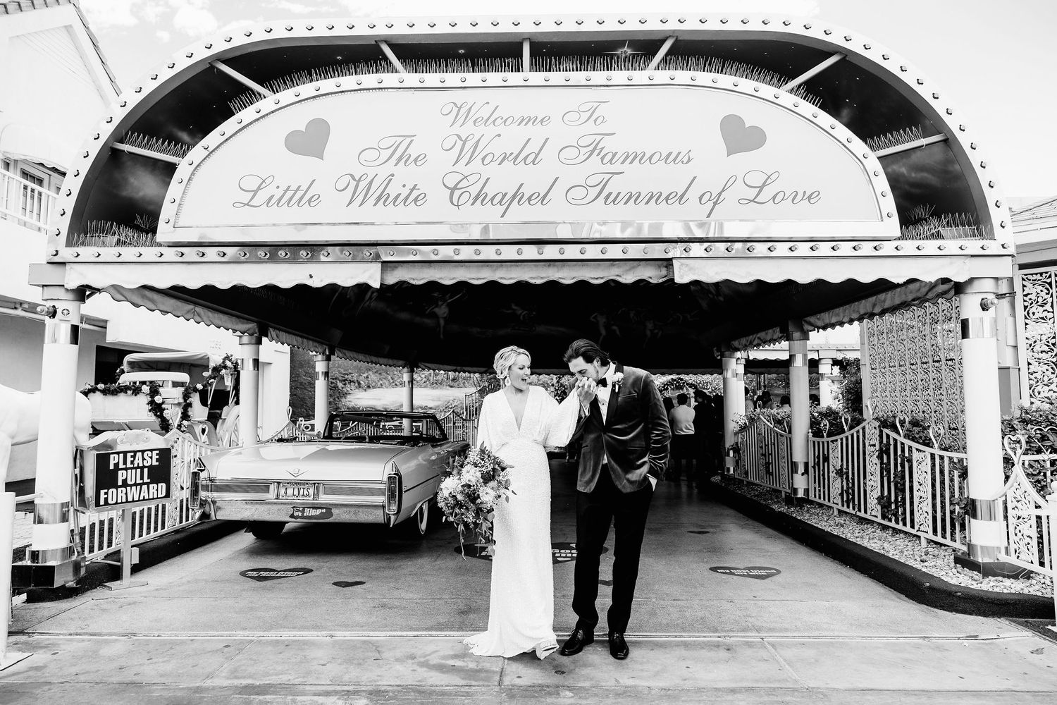 Panoramic black and white view of vintage wedding chapel exterior and signage.