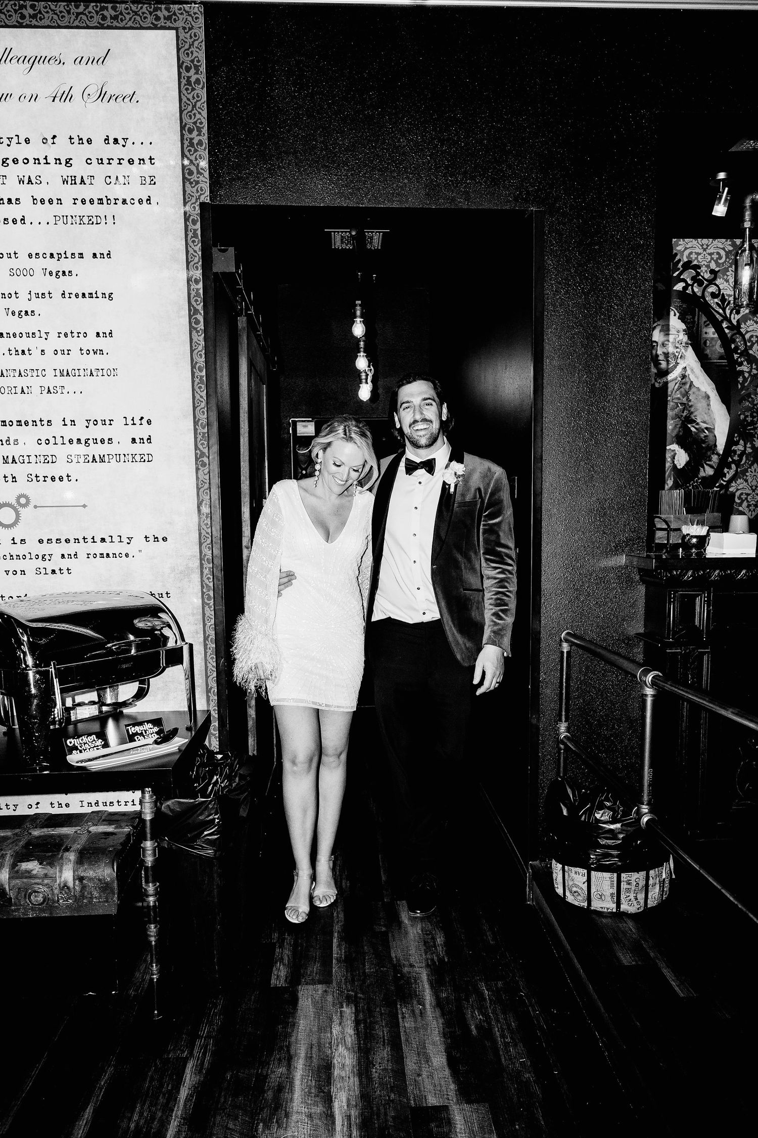 Black and white photos of a couple walking through an elegant indoor venue in formal attire.