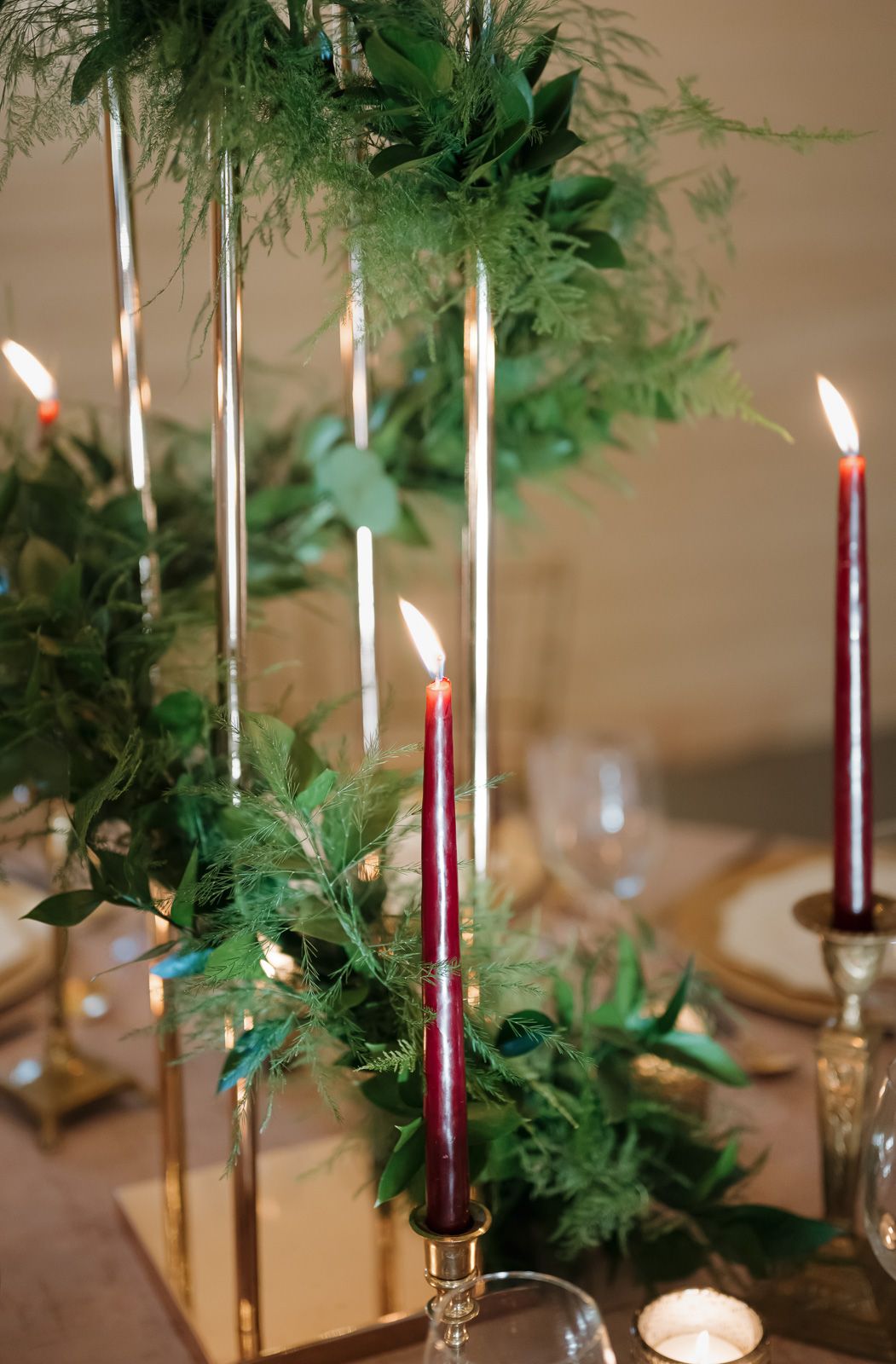 Elegant table setting with burgundy candles and fresh greenery garland for holiday entertaining taken by a New Jersey photographer.