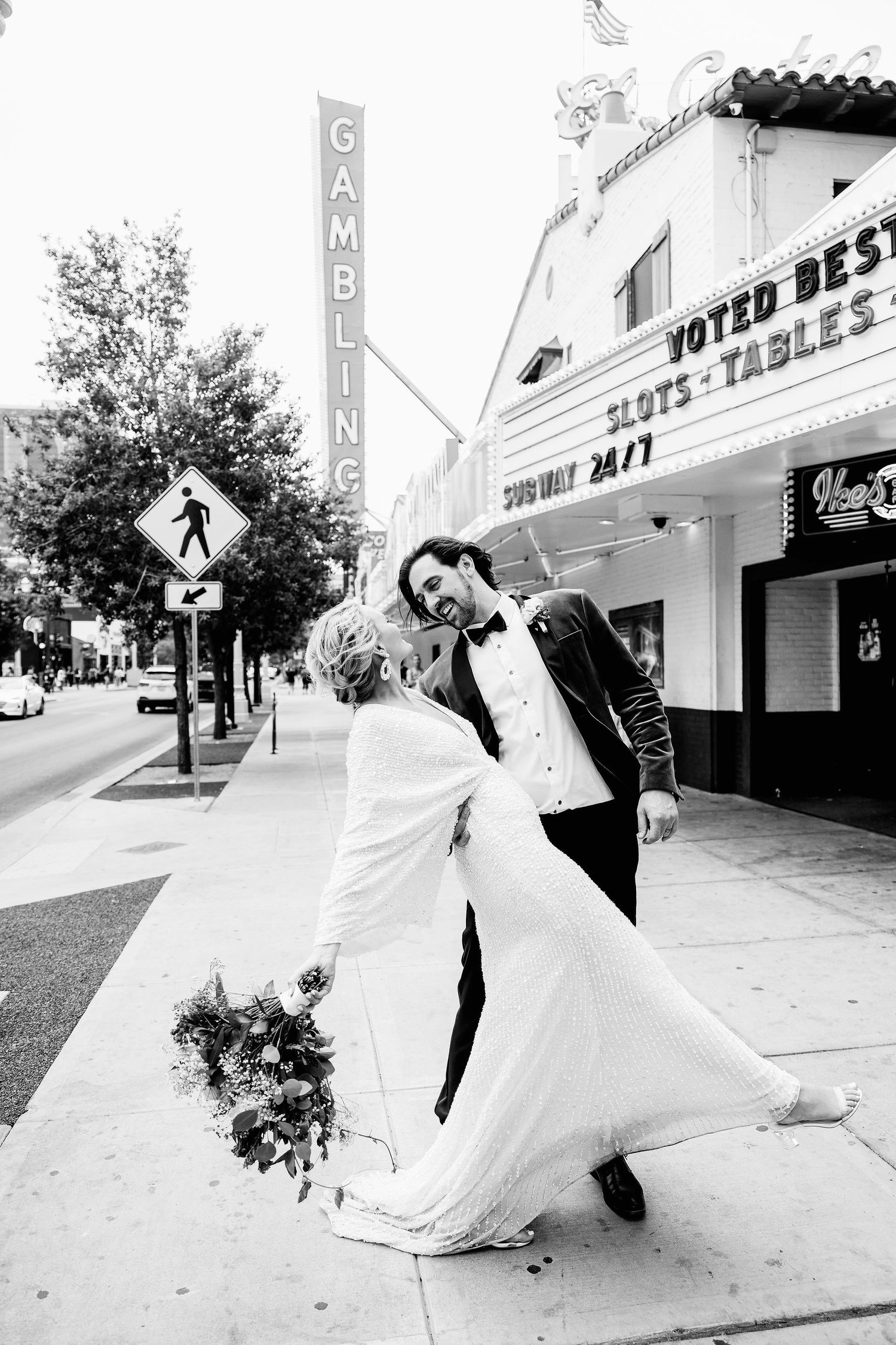 Series of playful wedding photos showing couple dancing and twirling on a city sidewalk.