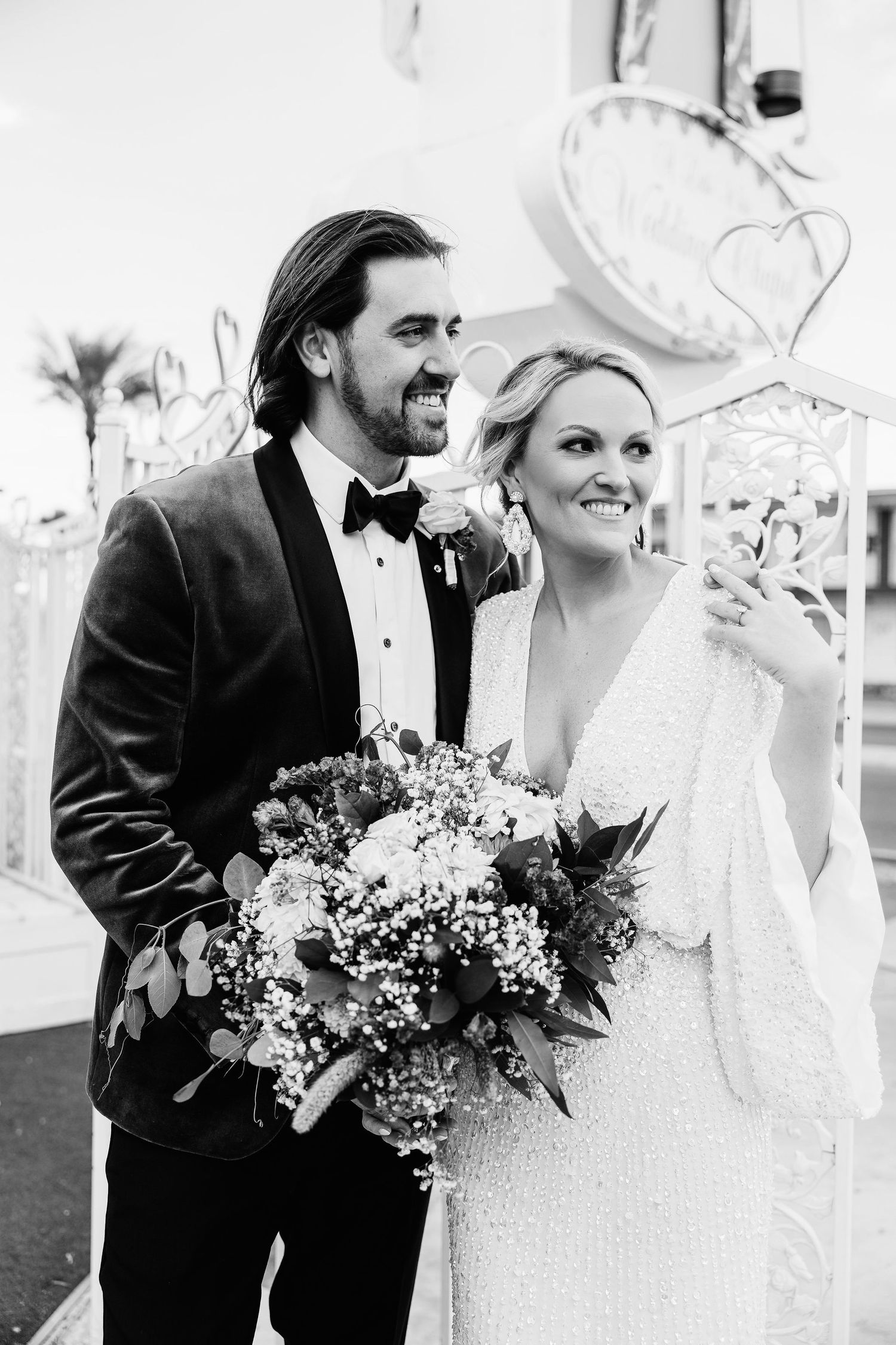 Black and white wedding portraits showing couple sharing intimate moments with bouquet.