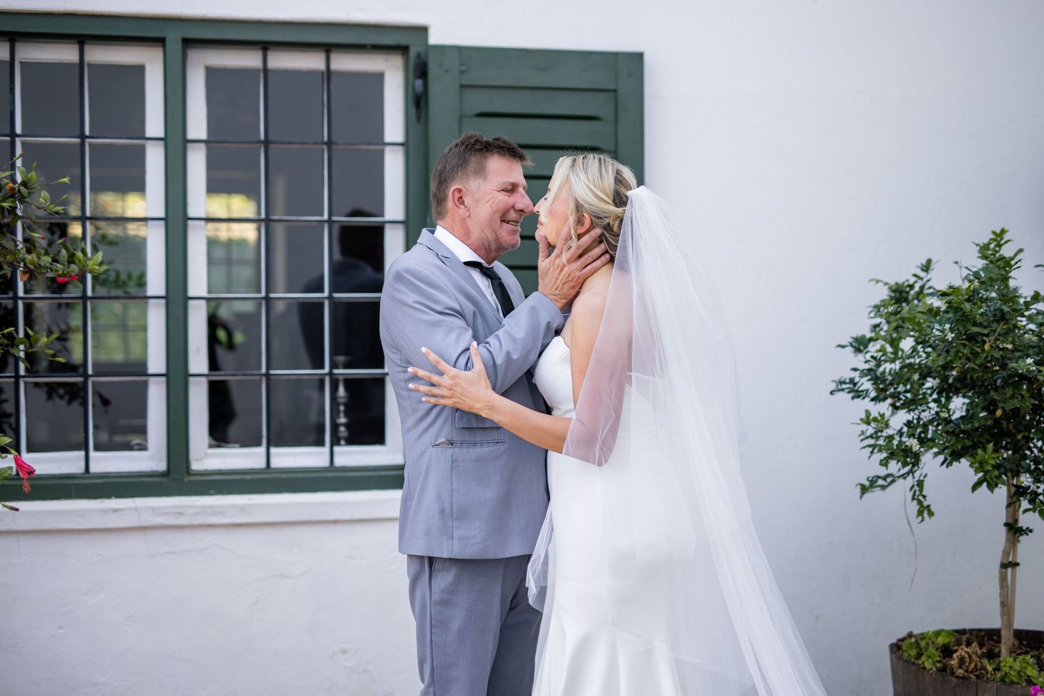 A couple shares an intimate moment during their outdoor wedding photoshoot.