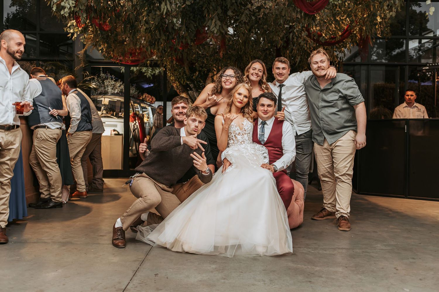 Wedding party enjoying a fun celebration moment on an outdoor dance floor.