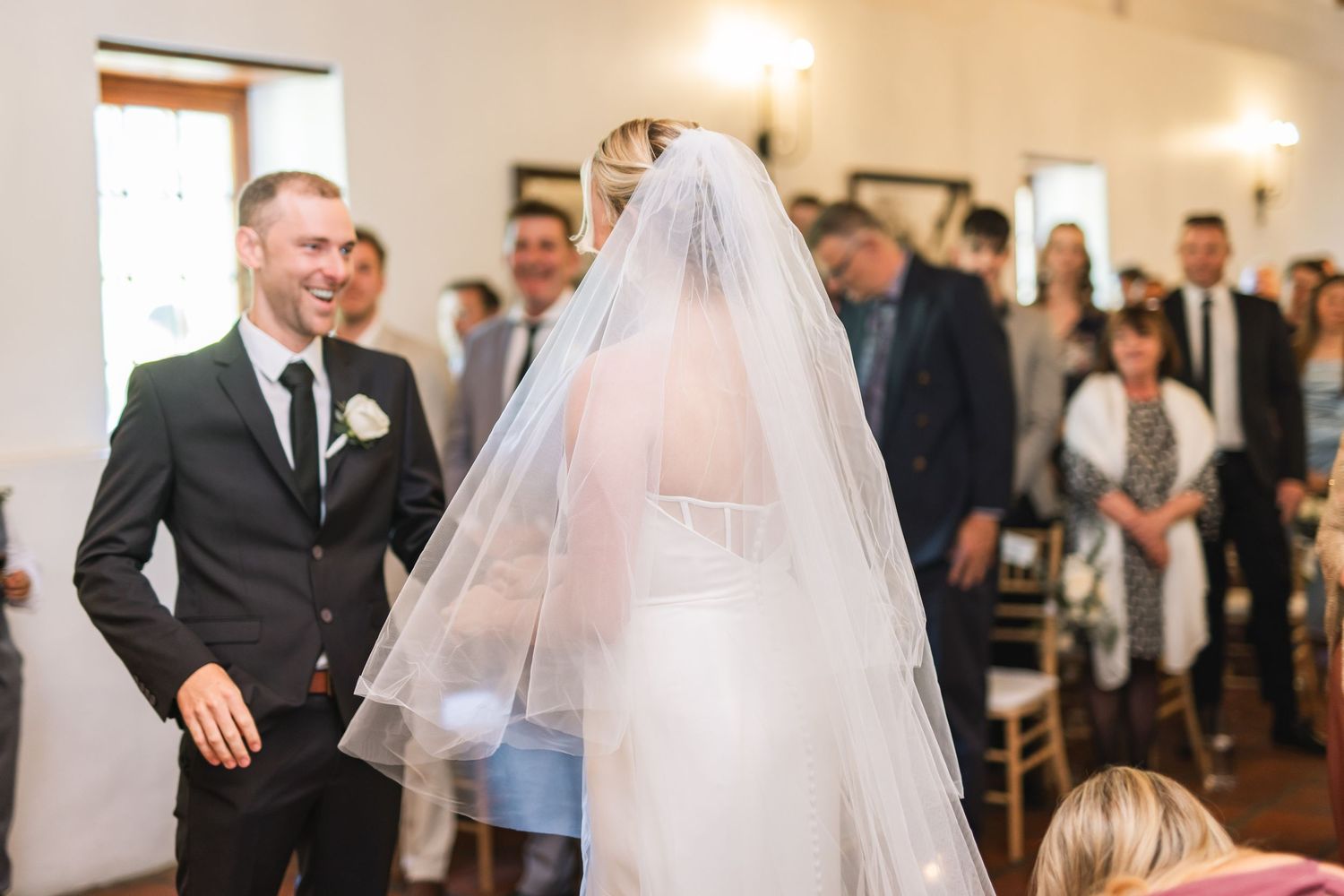 Wedding ceremony moments showing guests and a couple celebrating in an indoor venue.