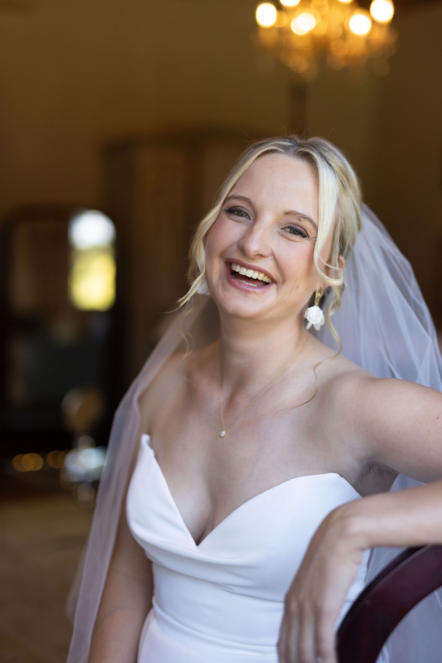 Candid sequence of a bride in a white wedding dress and veil against a warm-lit indoor backdrop.