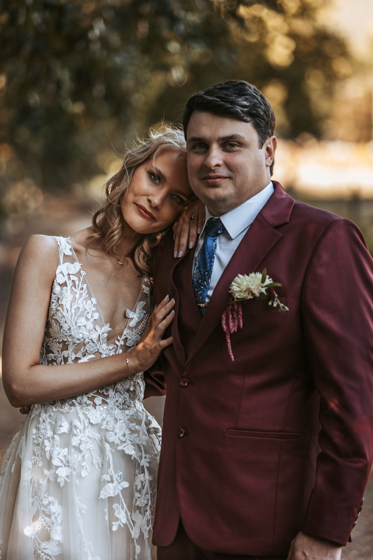 Romantic wedding portraits featuring delicate lace details and a burgundy suit.