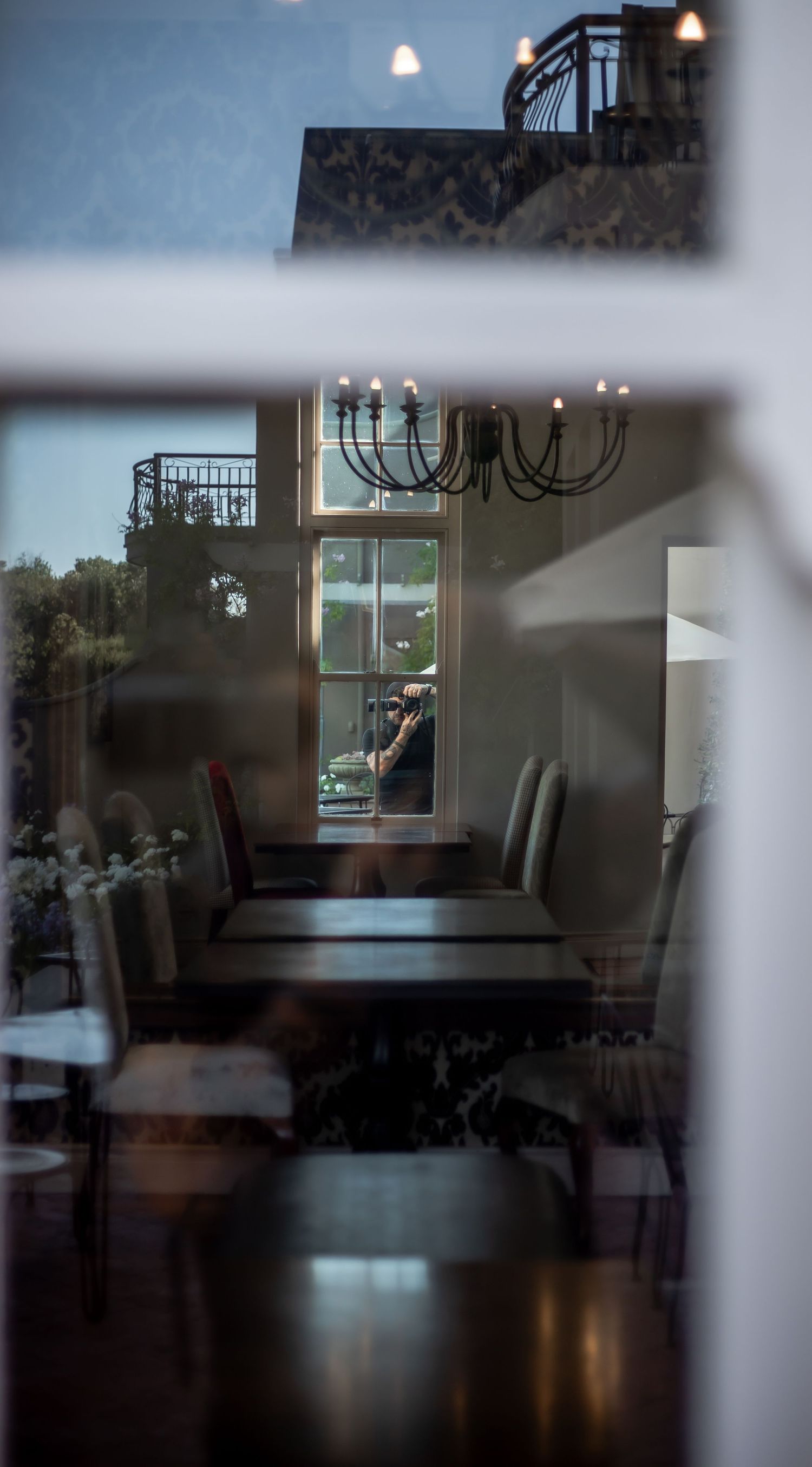 Interior shots of a modern home with dark hardwood floors and natural lighting through large windows.