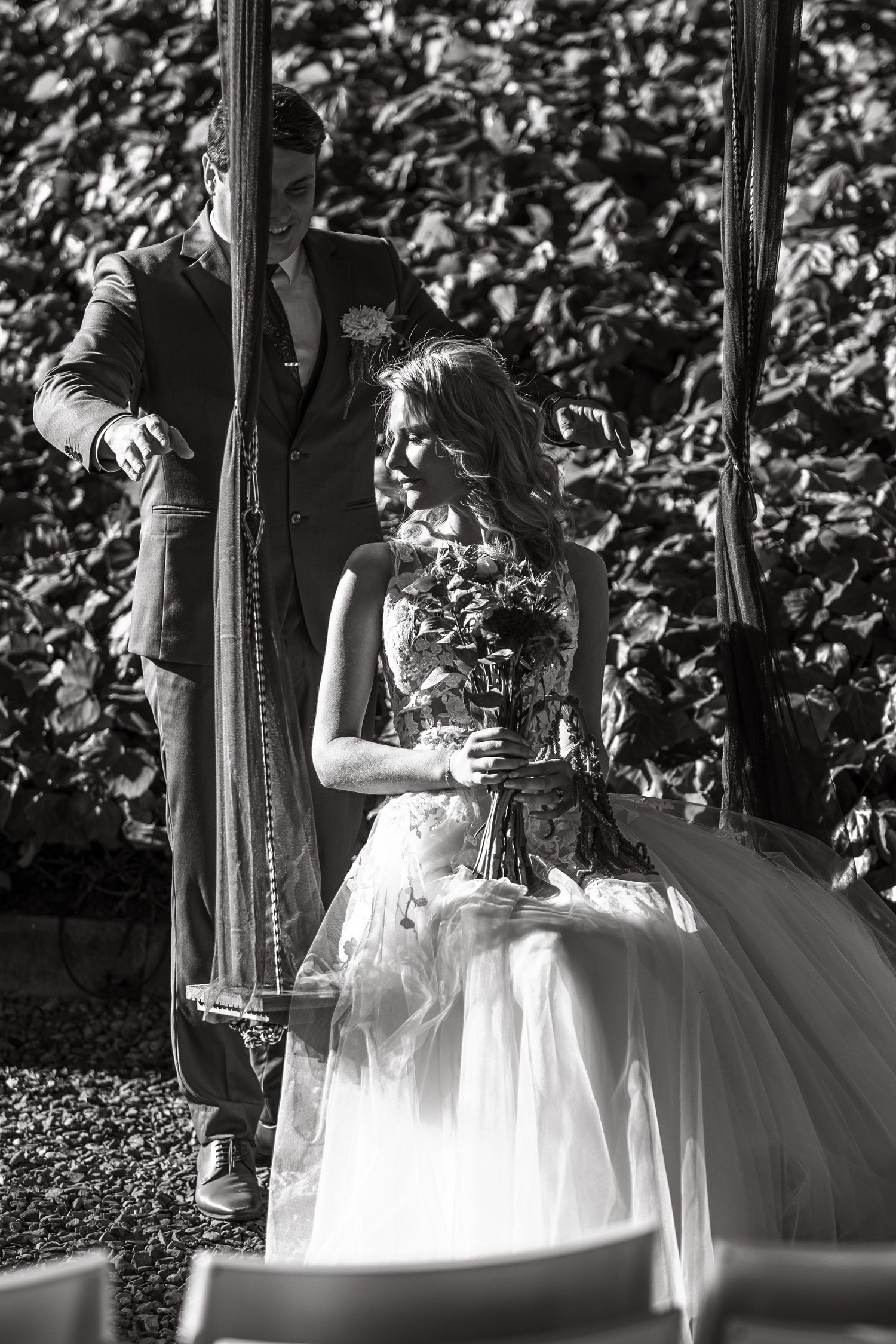 A couple dancing together in black and white, with the bride wearing a flowing white ballgown.