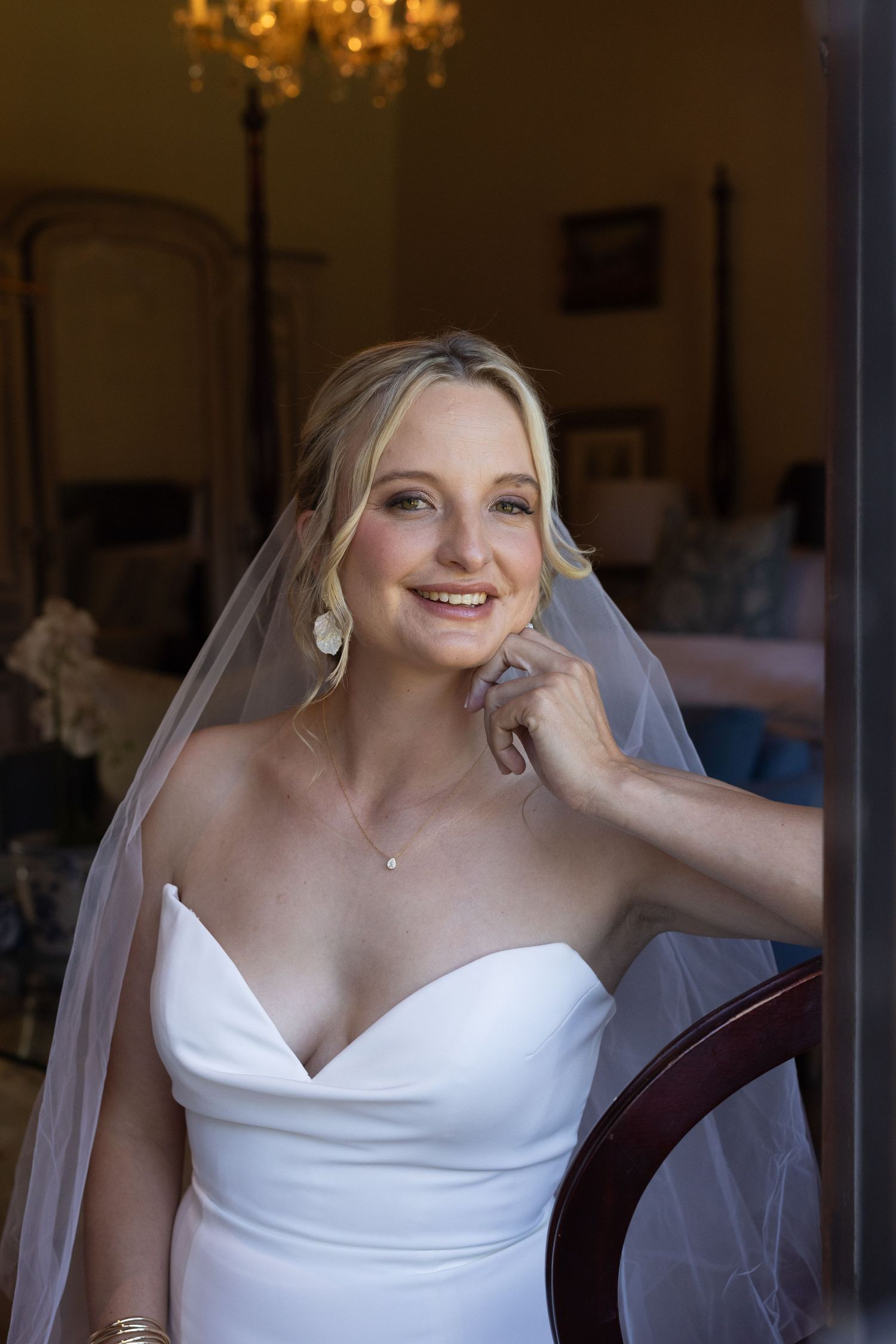 Candid bridal portraits showing joyful expressions and a flowing white wedding gown with veil.