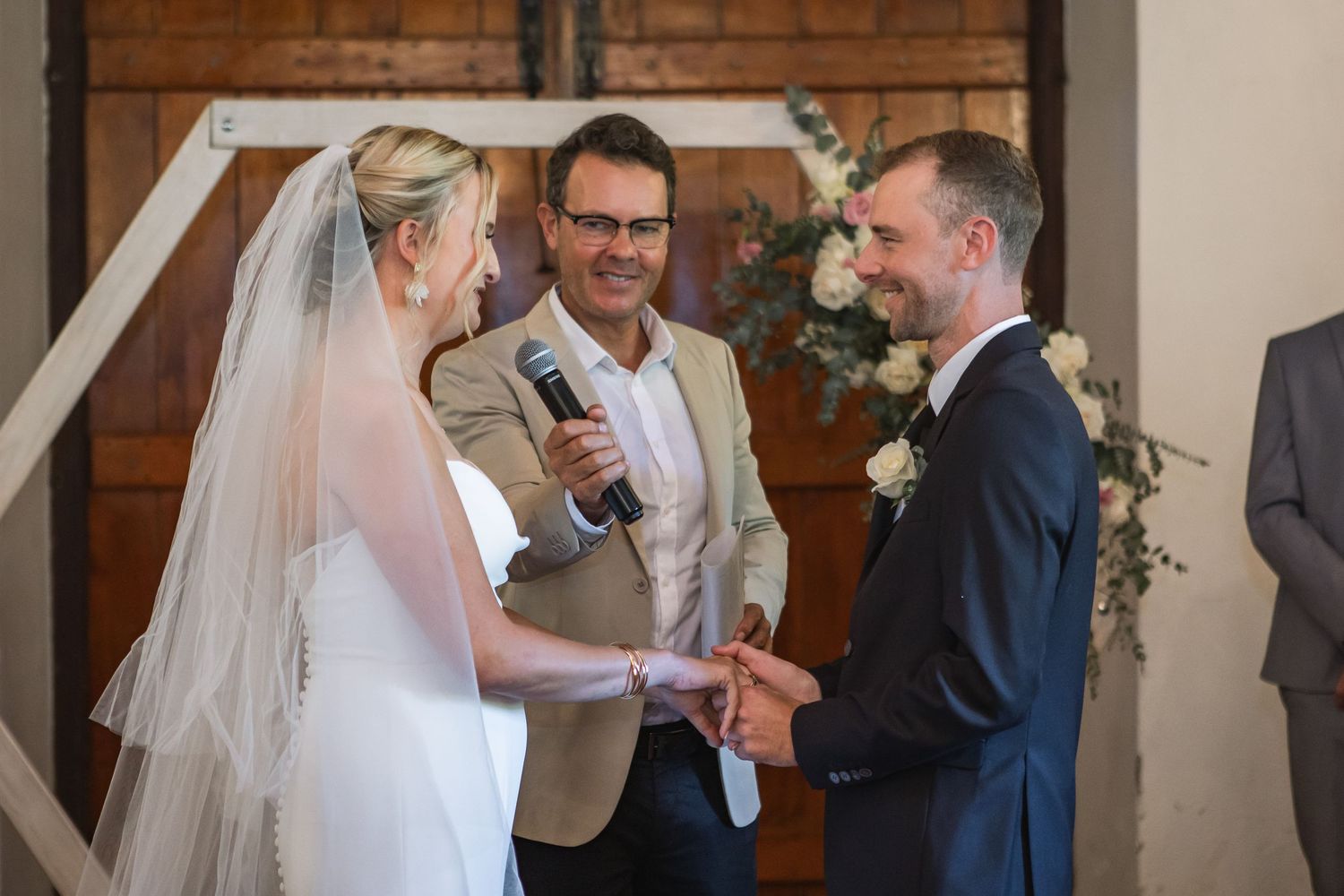 Wedding ceremony moments captured inside a historic brick building with natural lighting.