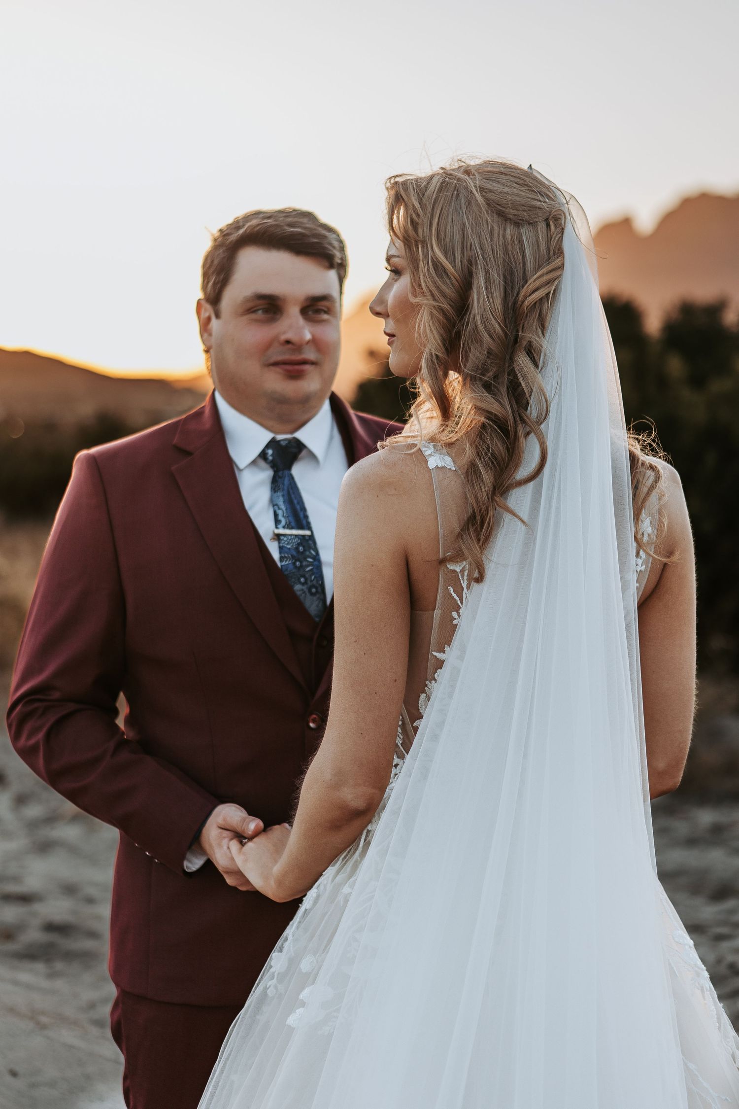 A sunset wedding portrait session with the couple against a warm evening sky.