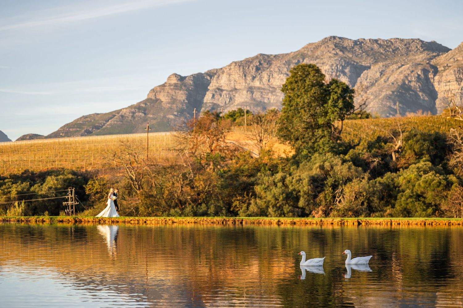 Panoramic mountain landscape at sunset with water reflections and natural scenery.
