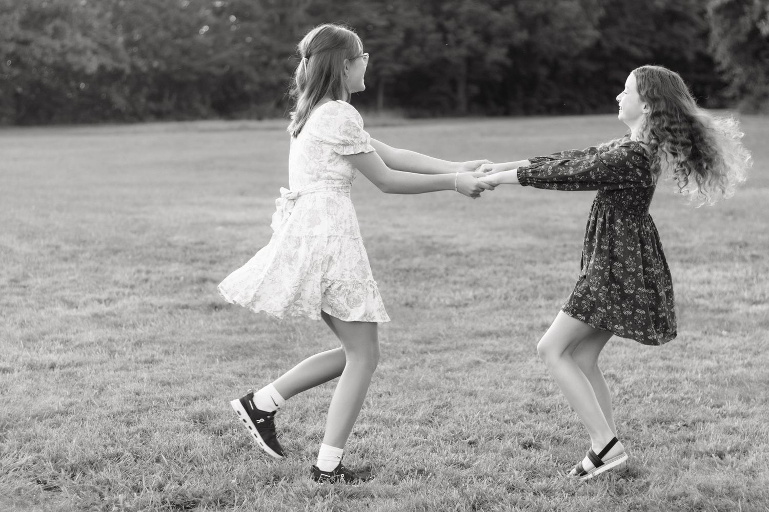 Black and white photo of playful movement in an open field.
