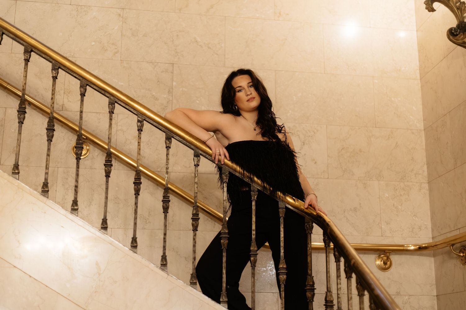 Elegant staircase photoshoot with dramatic lighting and vintage architecture.