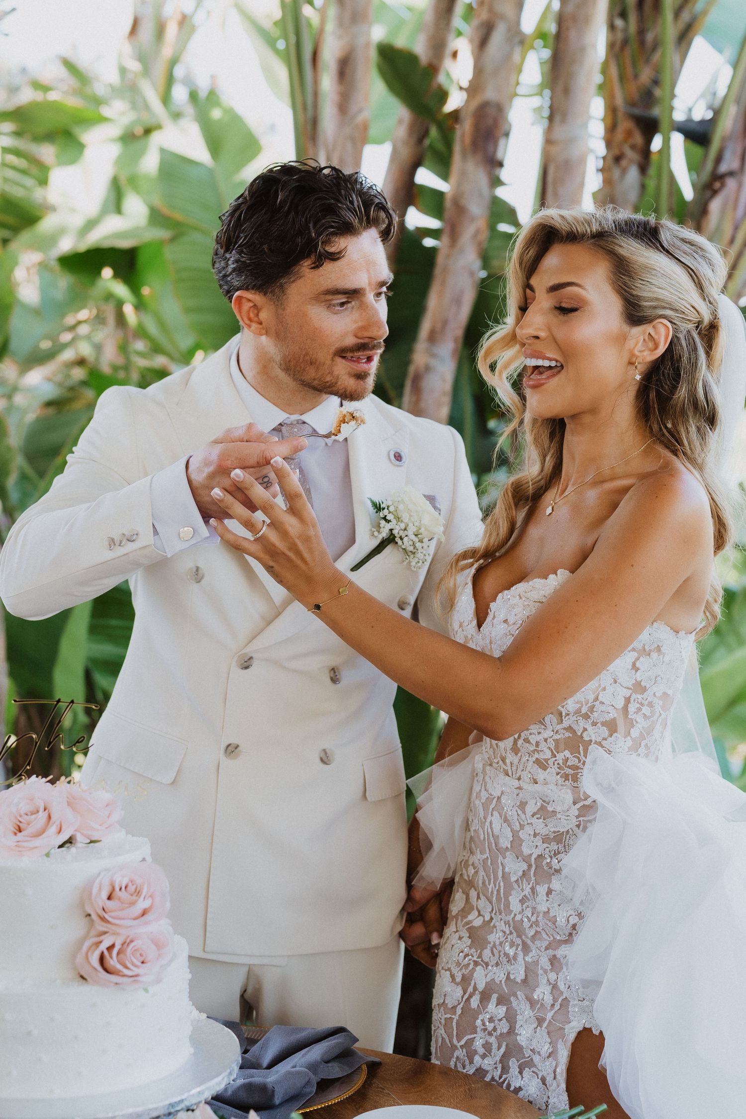 A romantic wedding sequence shows a couple in white sharing playful and joyful moments among tropical foliage.