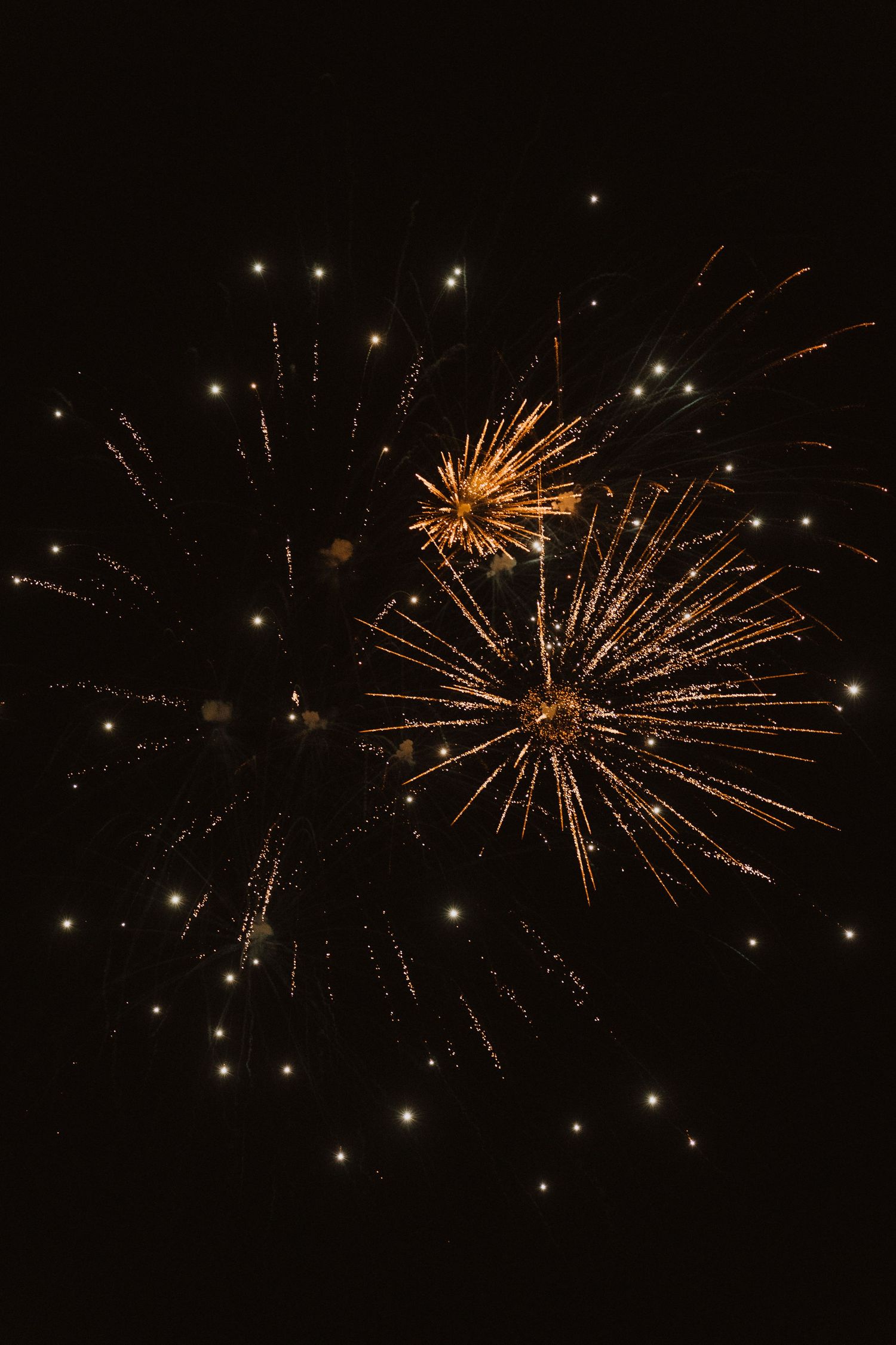 Golden fireworks bursting against dark night sky in sequential panoramic shots.