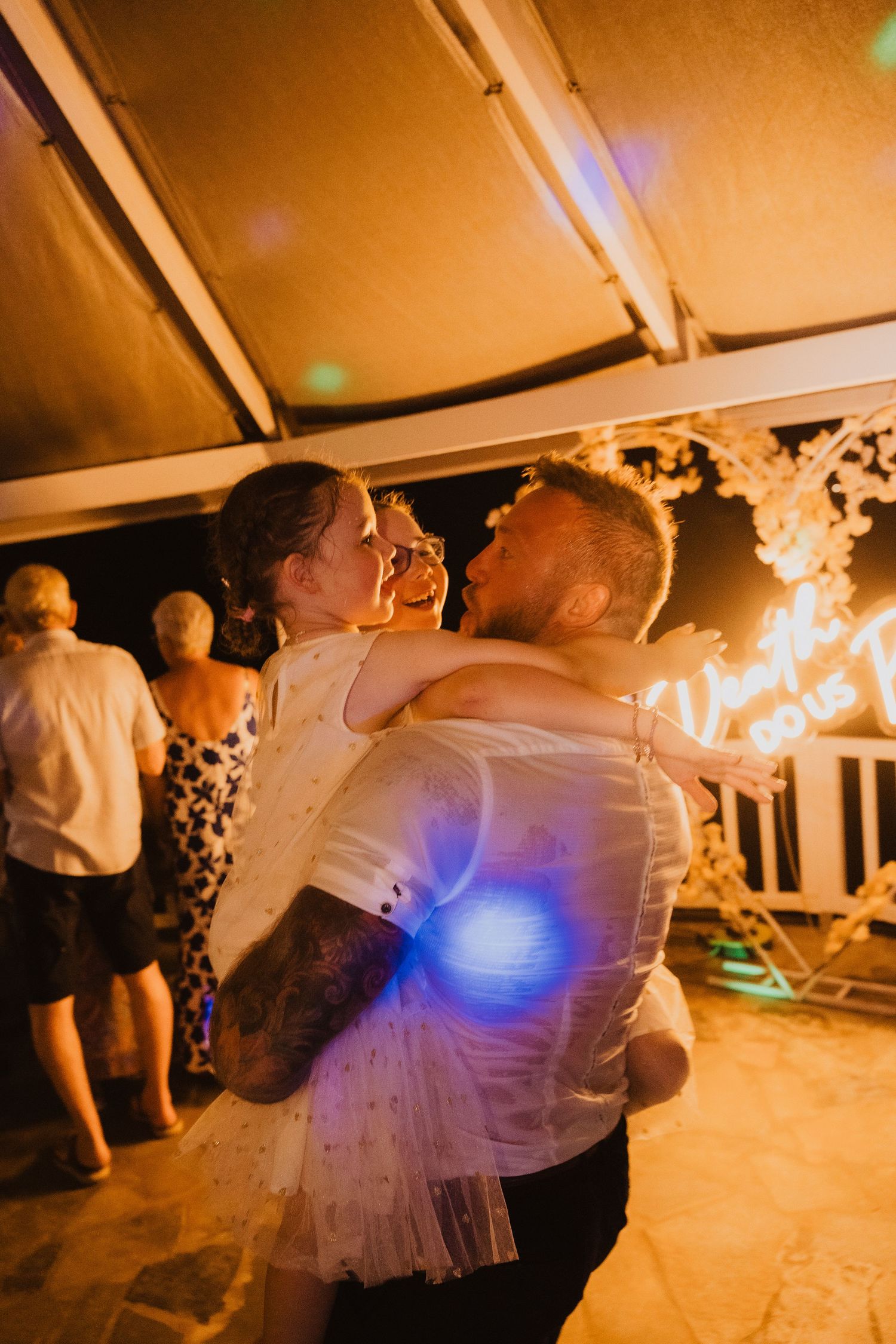 A tender dance moment captured during an evening wedding reception under warm lighting.