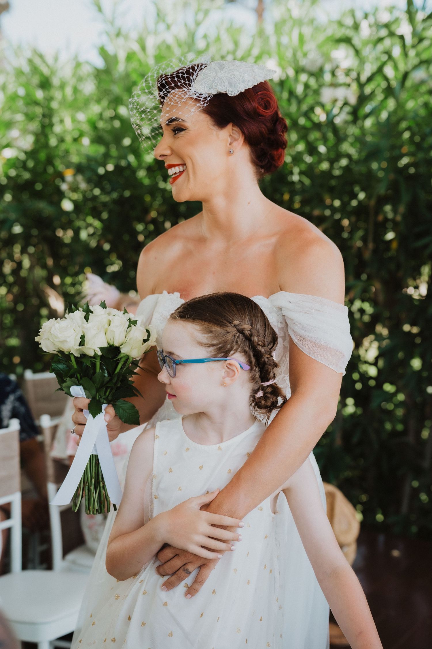 A joyful moment captured during an outdoor garden wedding celebration.