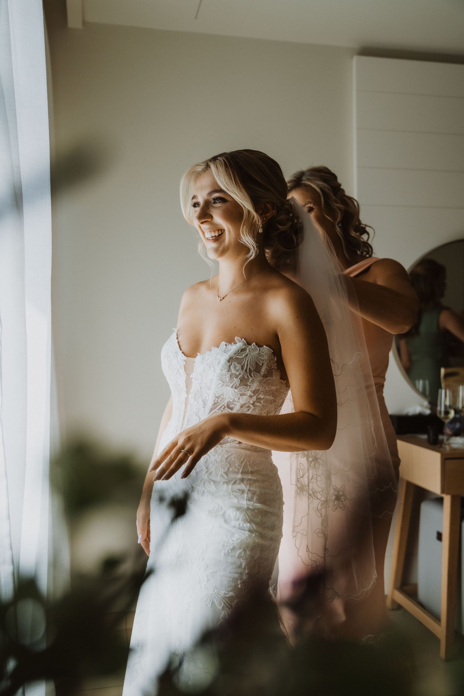 Artistic wedding preparation shot with natural window light.