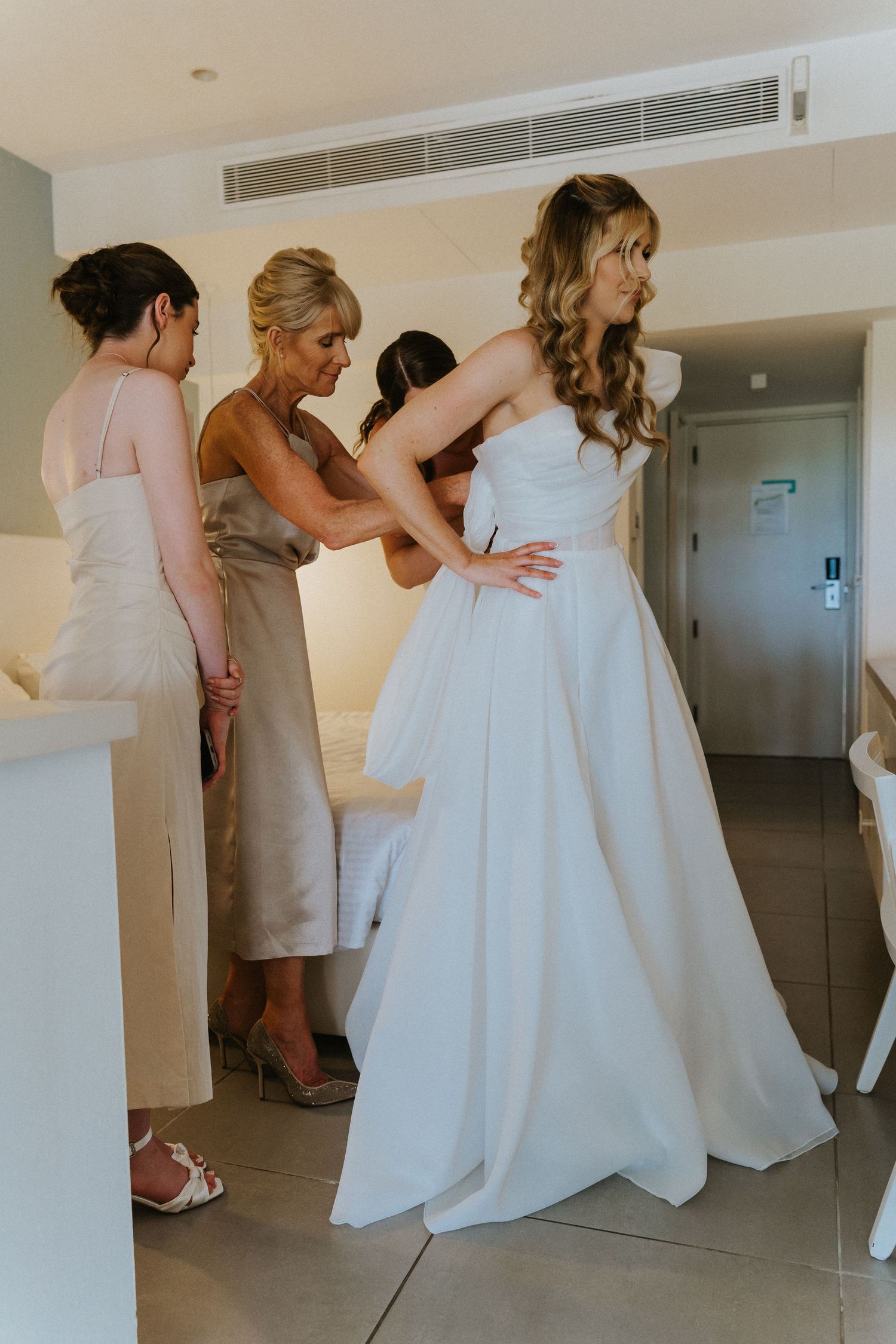 A serene moment of wedding dress preparation in a sunlit room.