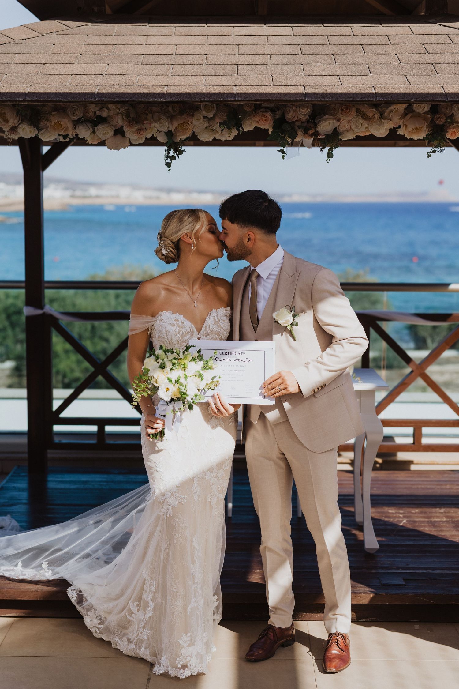 Romantic wedding moments captured on a decorated oceanfront terrace.