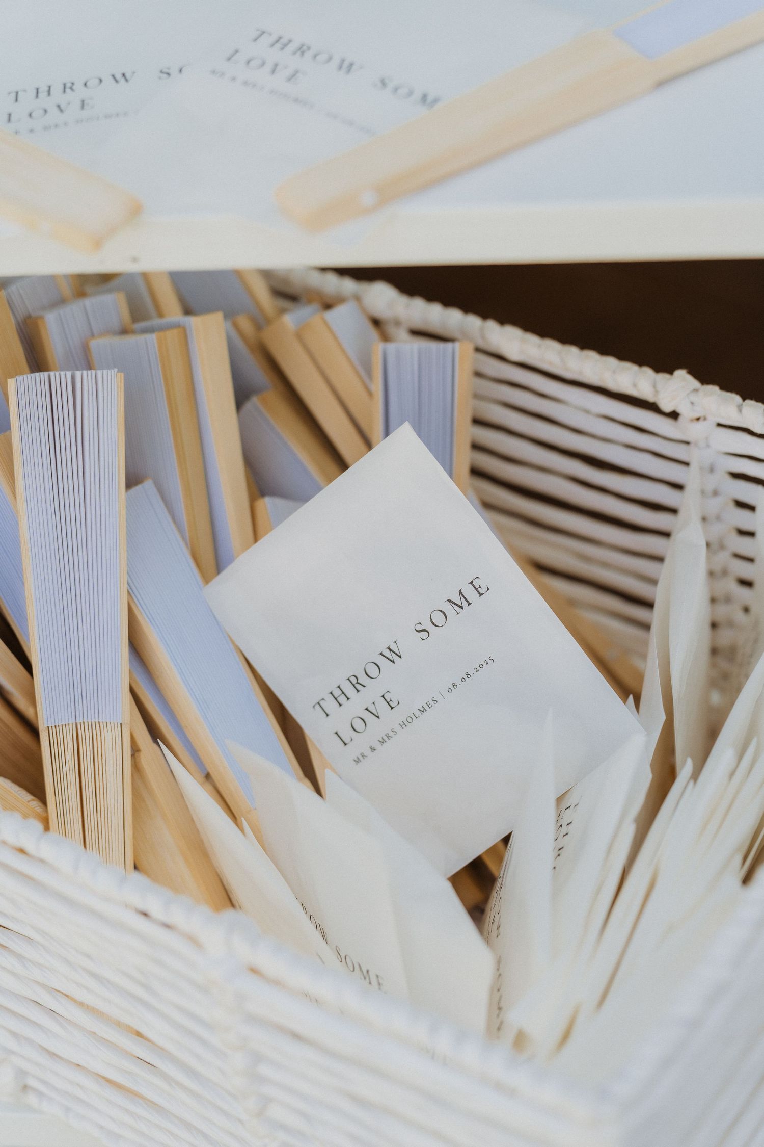 Close-up view of scattered white business cards with minimalist design against a wooden surface.