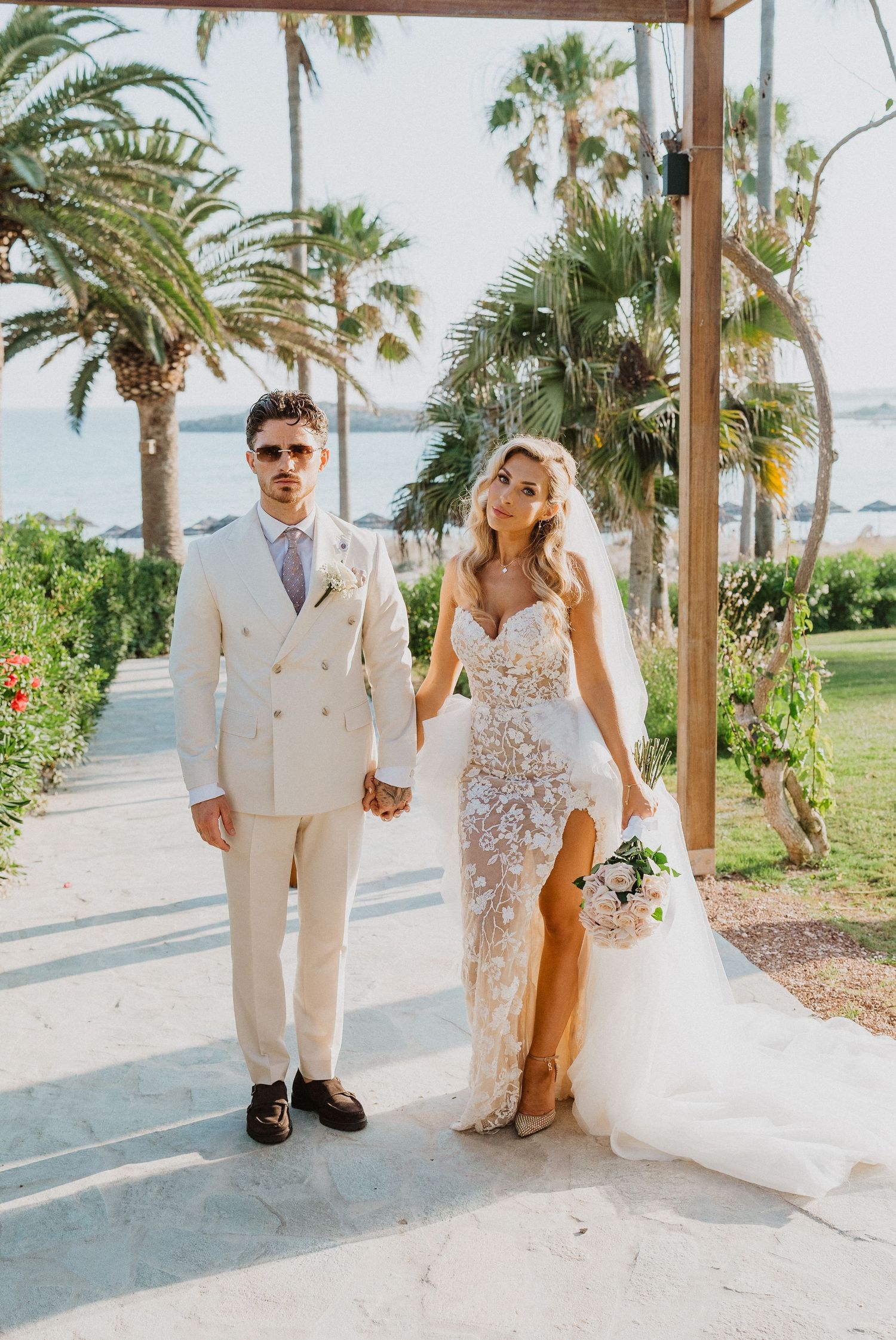A series of romantic beach wedding photos showing a couple in white attire posing under palm trees by the ocean.