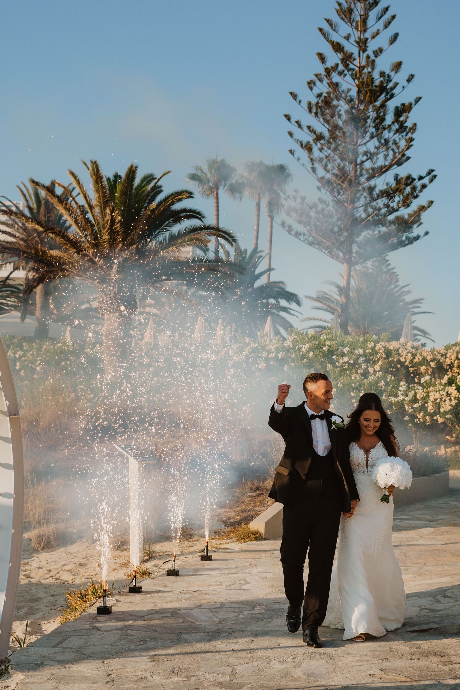 Wedding celebration with sparkling water fountains creating a magical atmosphere in an outdoor venue.