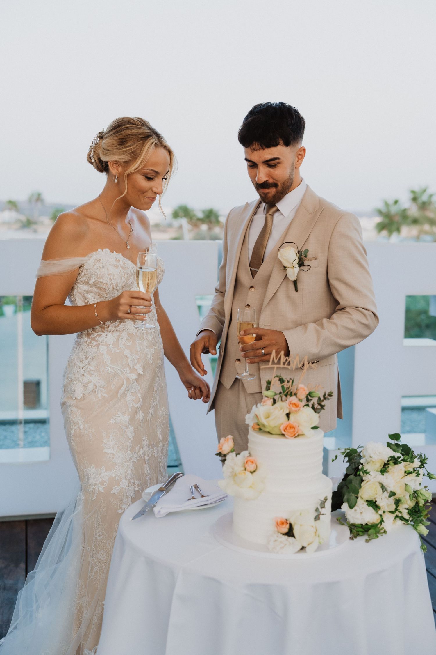 Newlyweds sharing cake during their wedding reception.