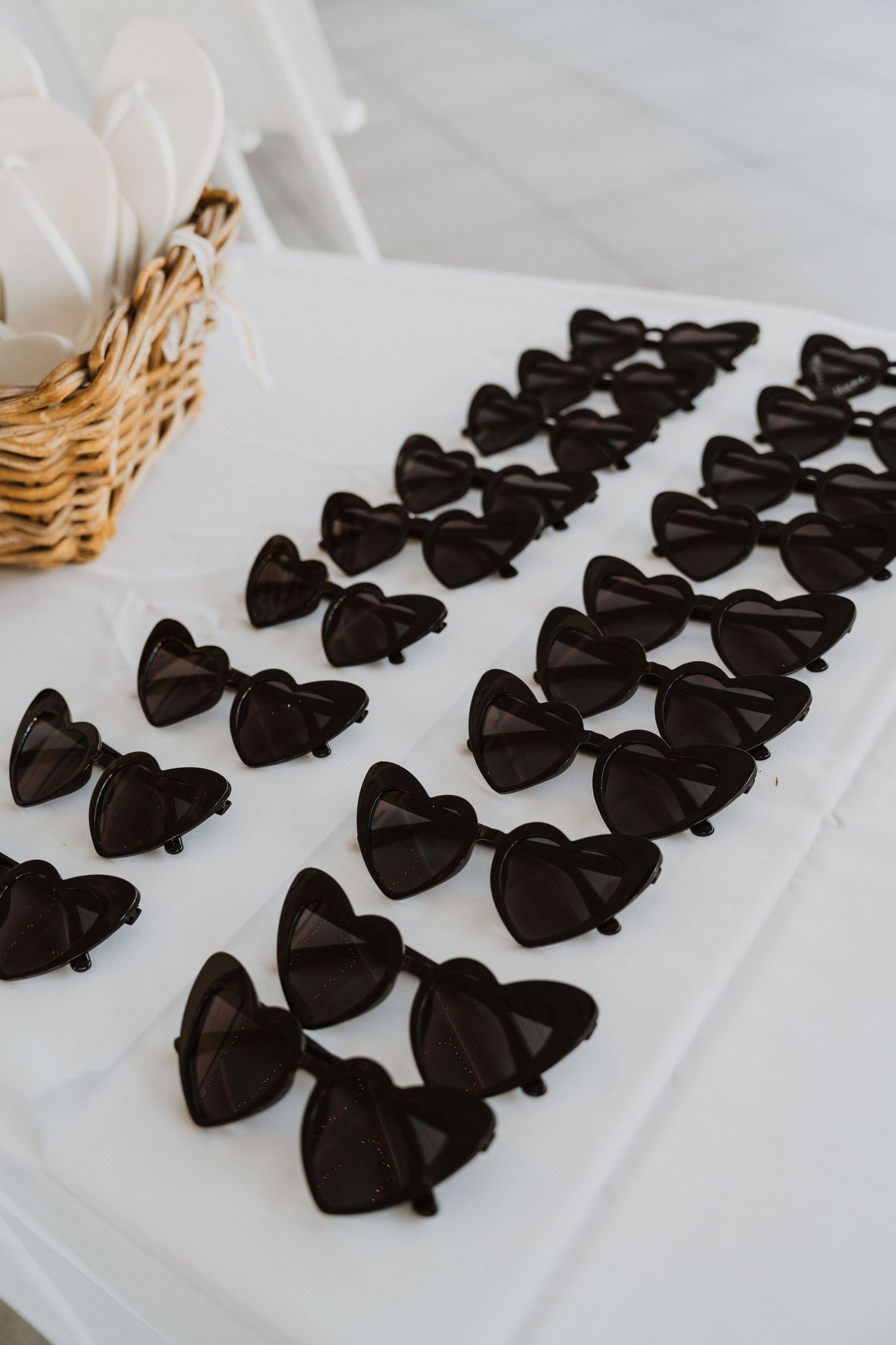 Rows of black bow ties neatly arranged on a white surface for a formal event.