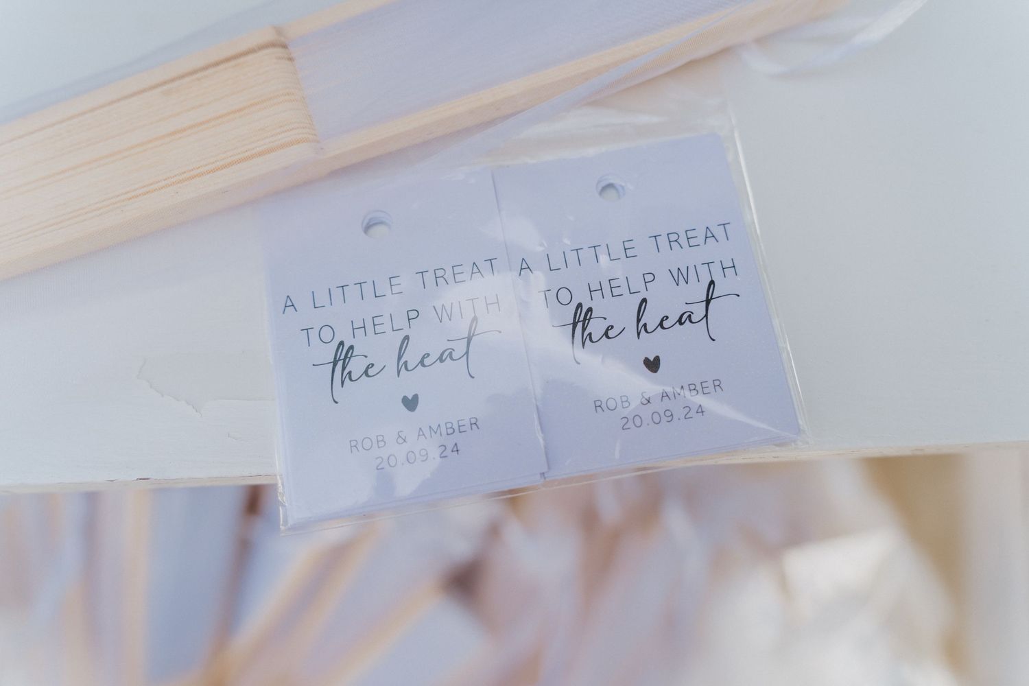 A close-up view of a handwritten note card with romantic text and small heart drawings on white paper.