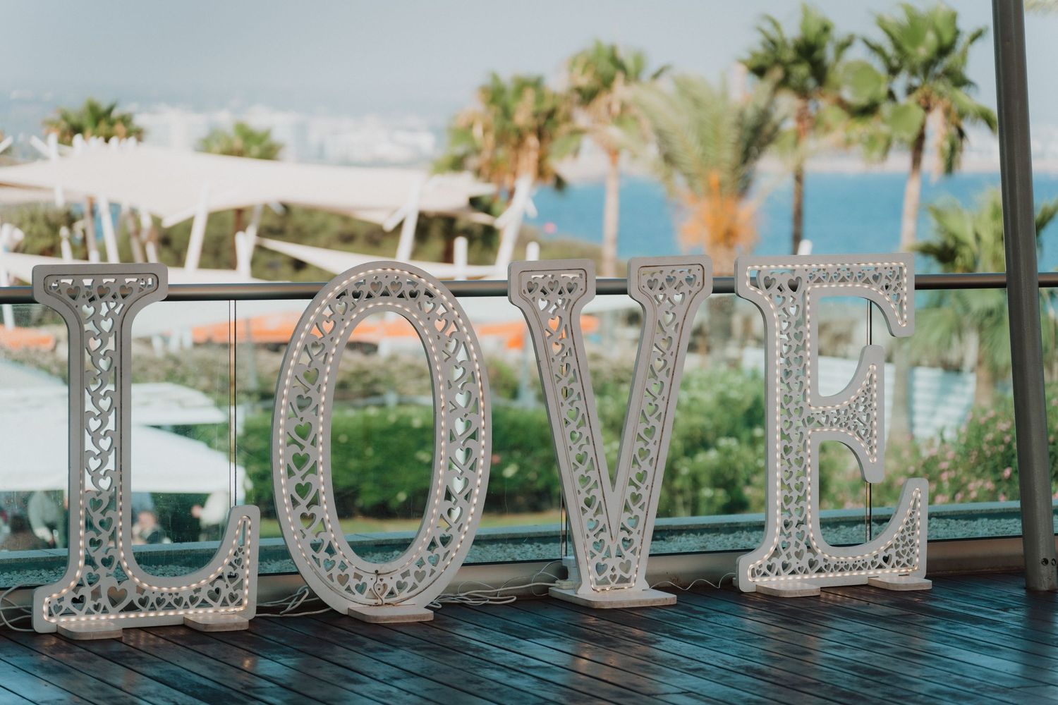 Decorative crystal 'LOVE' letters displayed at oceanfront wedding venue.