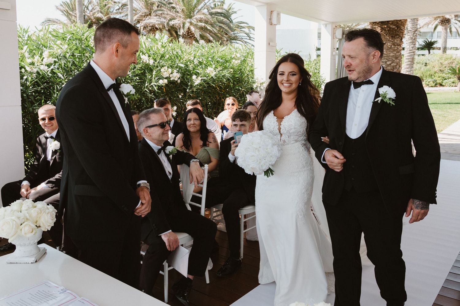 Bride and groom share an intimate moment during their wedding ceremony on a covered outdoor patio.