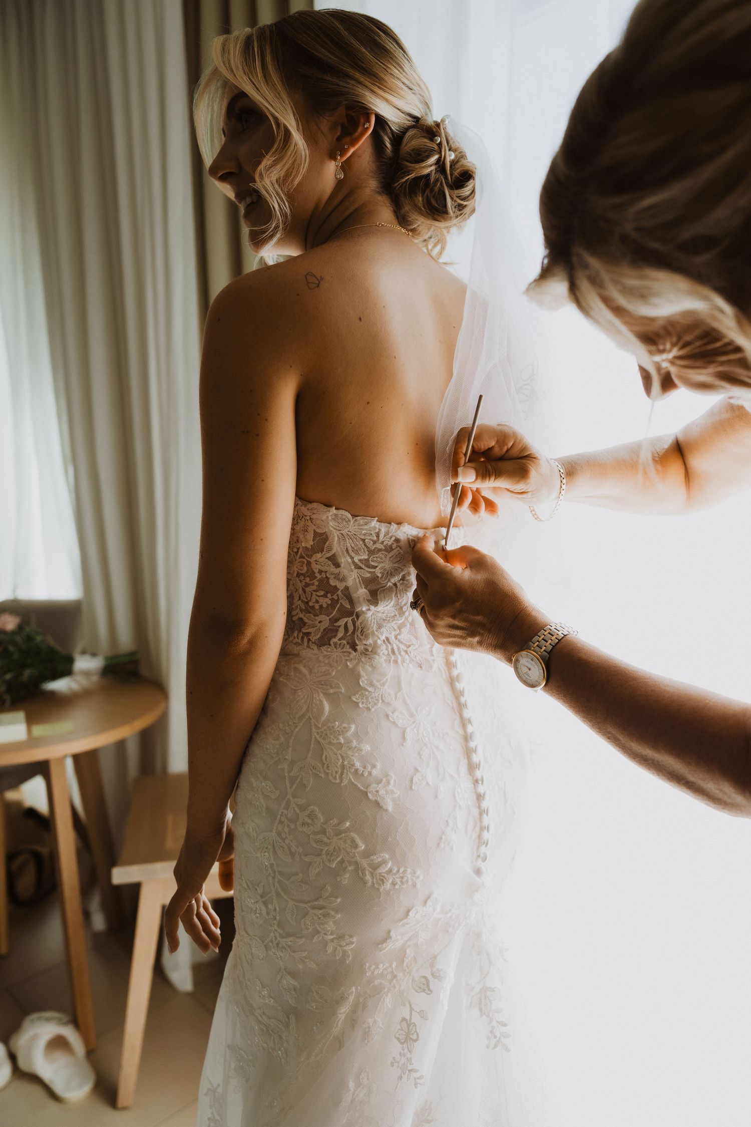 Multiple angles showing the intricate back details of a fitted lace wedding dress.