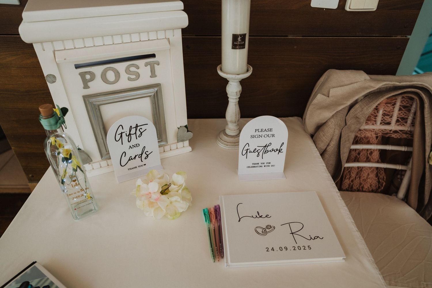 Wedding guest book and welcome table setup with white decor elements.