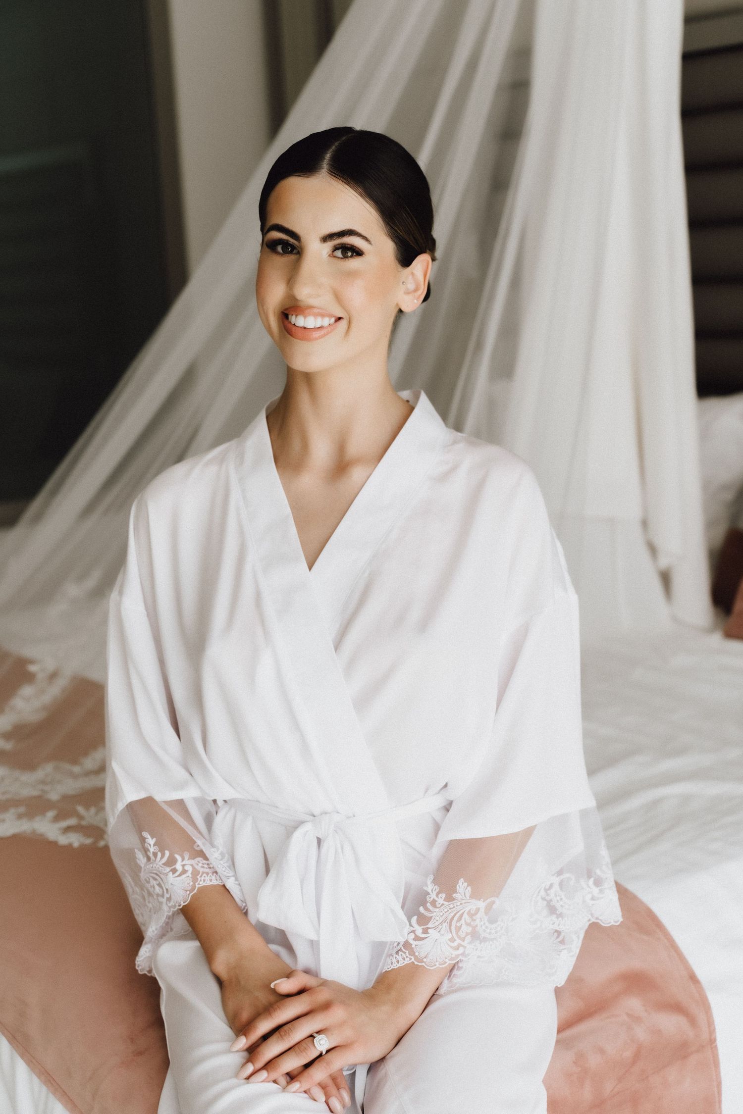 Wedding preparation scene with bridal robe and wedding dress backdrop.