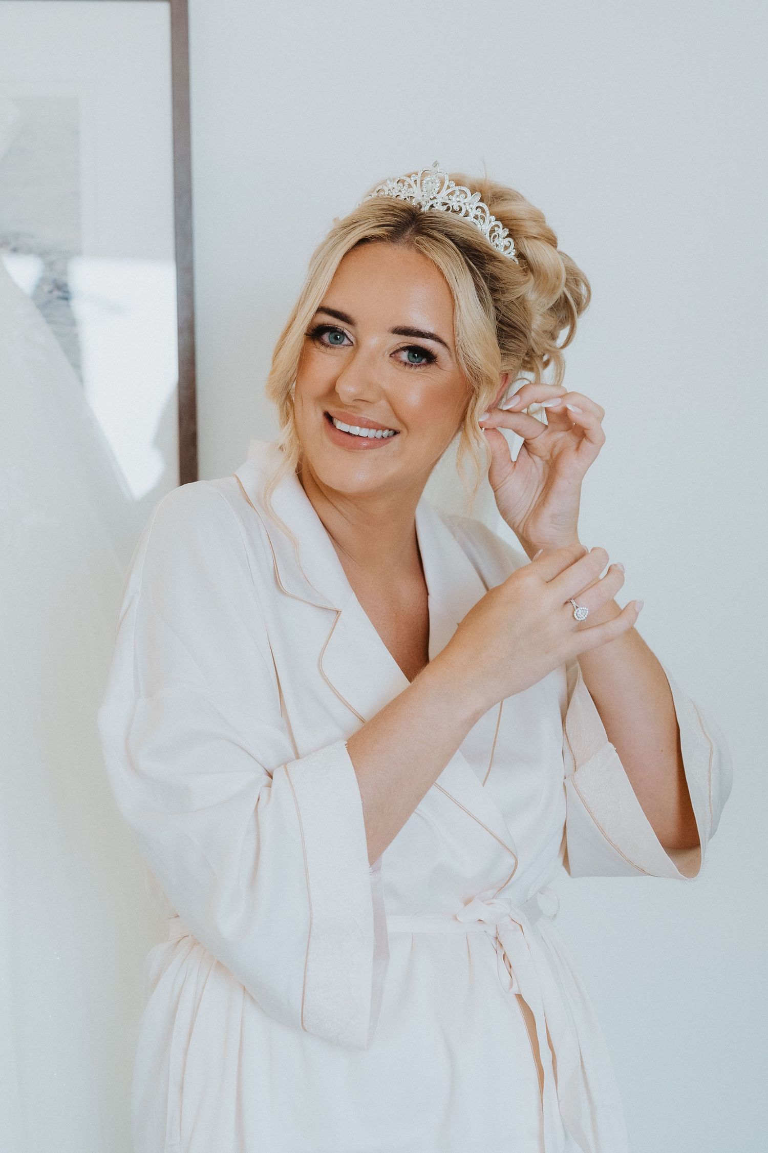 A beautiful wedding day preparation moment in a white robe.