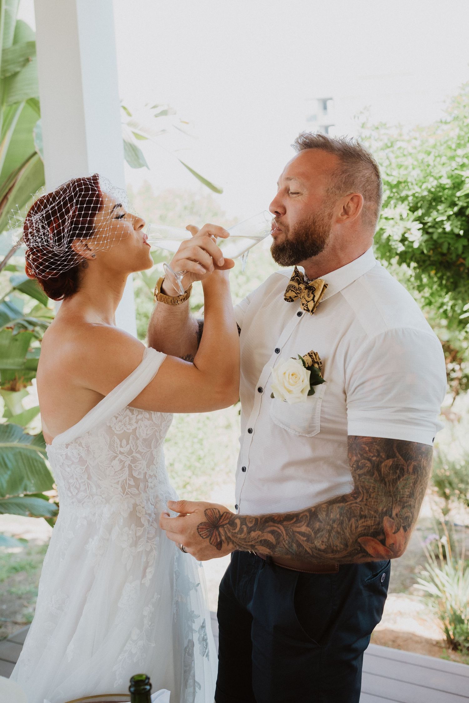 Couple sharing cake while celebrating their wedding day.