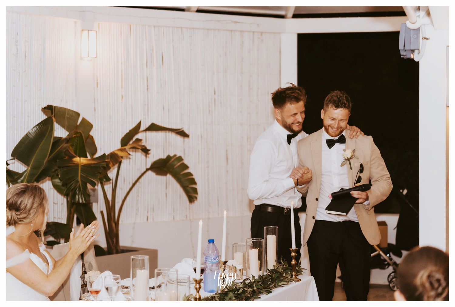 Bartenders serving drinks at an elegant wedding reception bar.