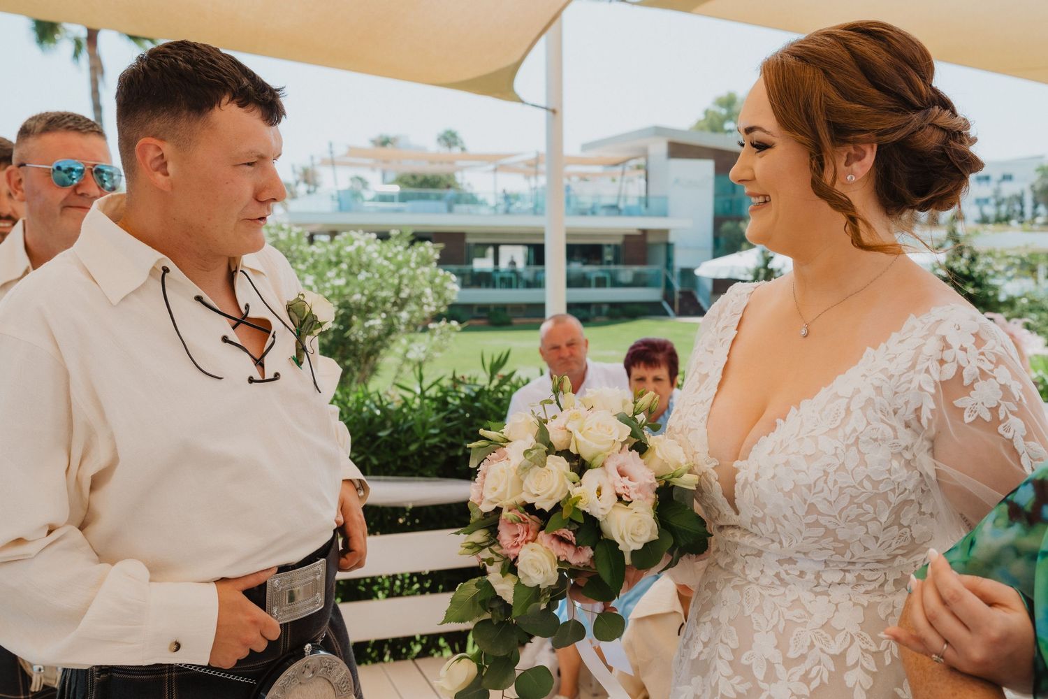Intimate moment at outdoor wedding ceremony with Scottish cultural elements.