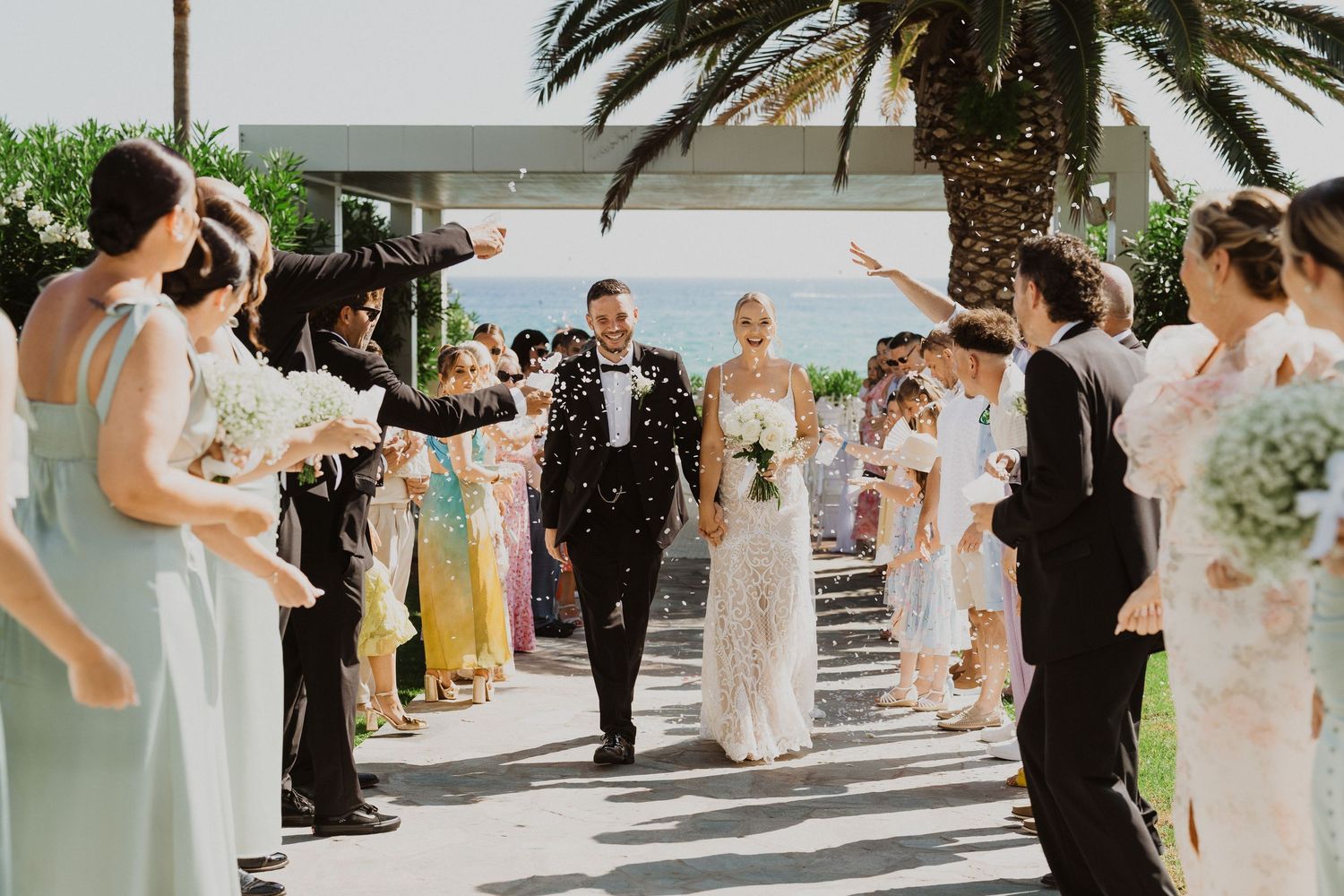 Wedding celebration continues with dancing and festivities at a tropical beachfront location.