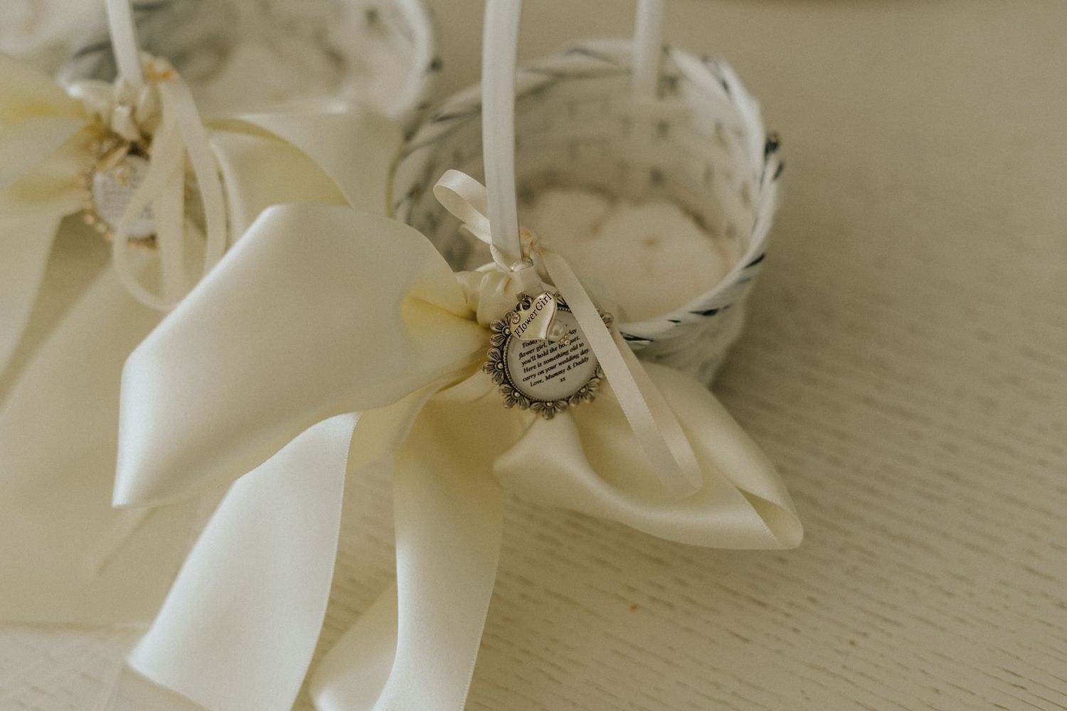 Decorative white bow with crystal brooch detail on light background.